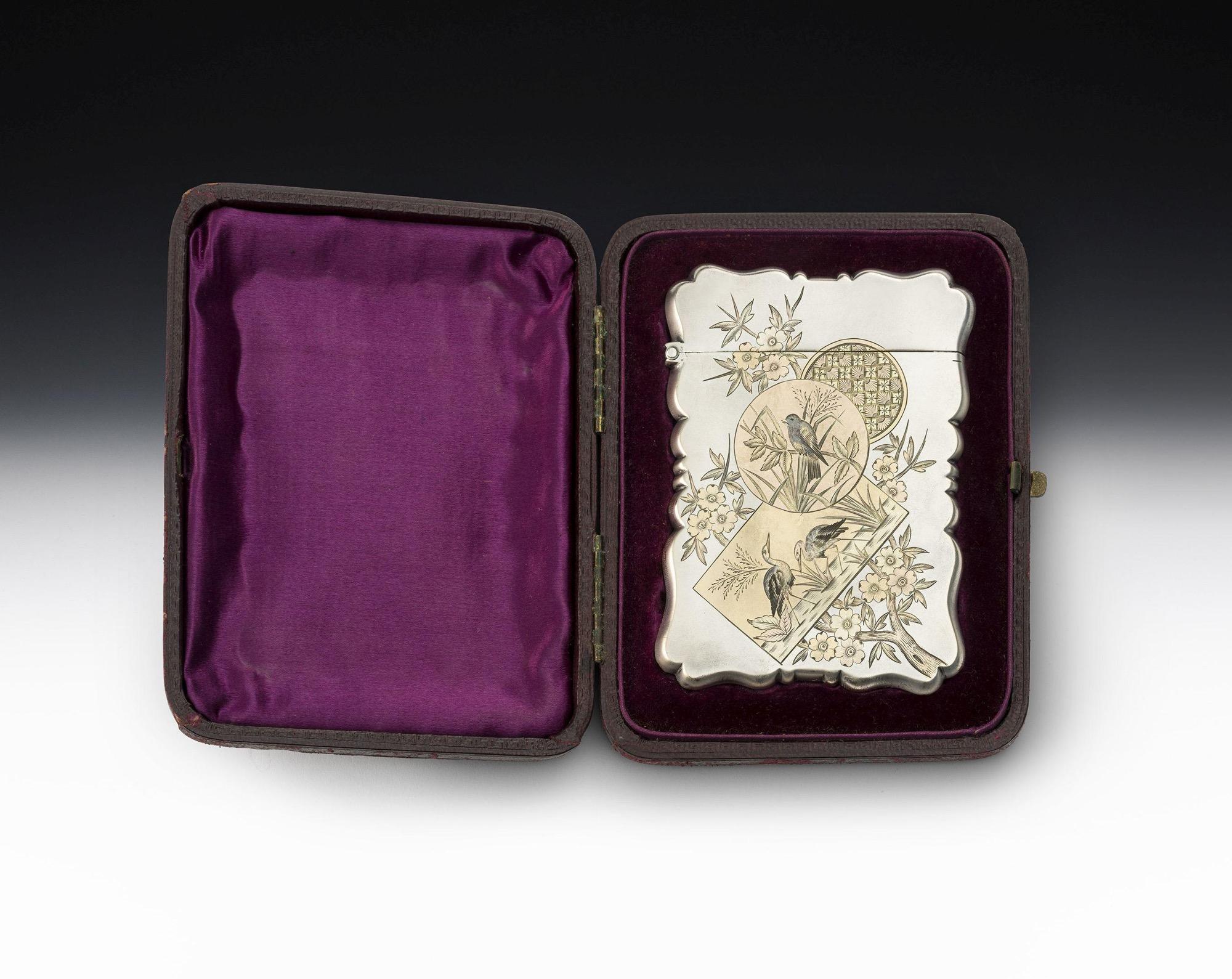 The Aesthetic Movement. A Very Rare and Exceptionally Fine Silver and Two Colour Gold Card Case Made in Birmingham in 1885 by George Unite.

The card case is of broad rectangular form with serpentine shaped sides and a hinged cover. The sides are