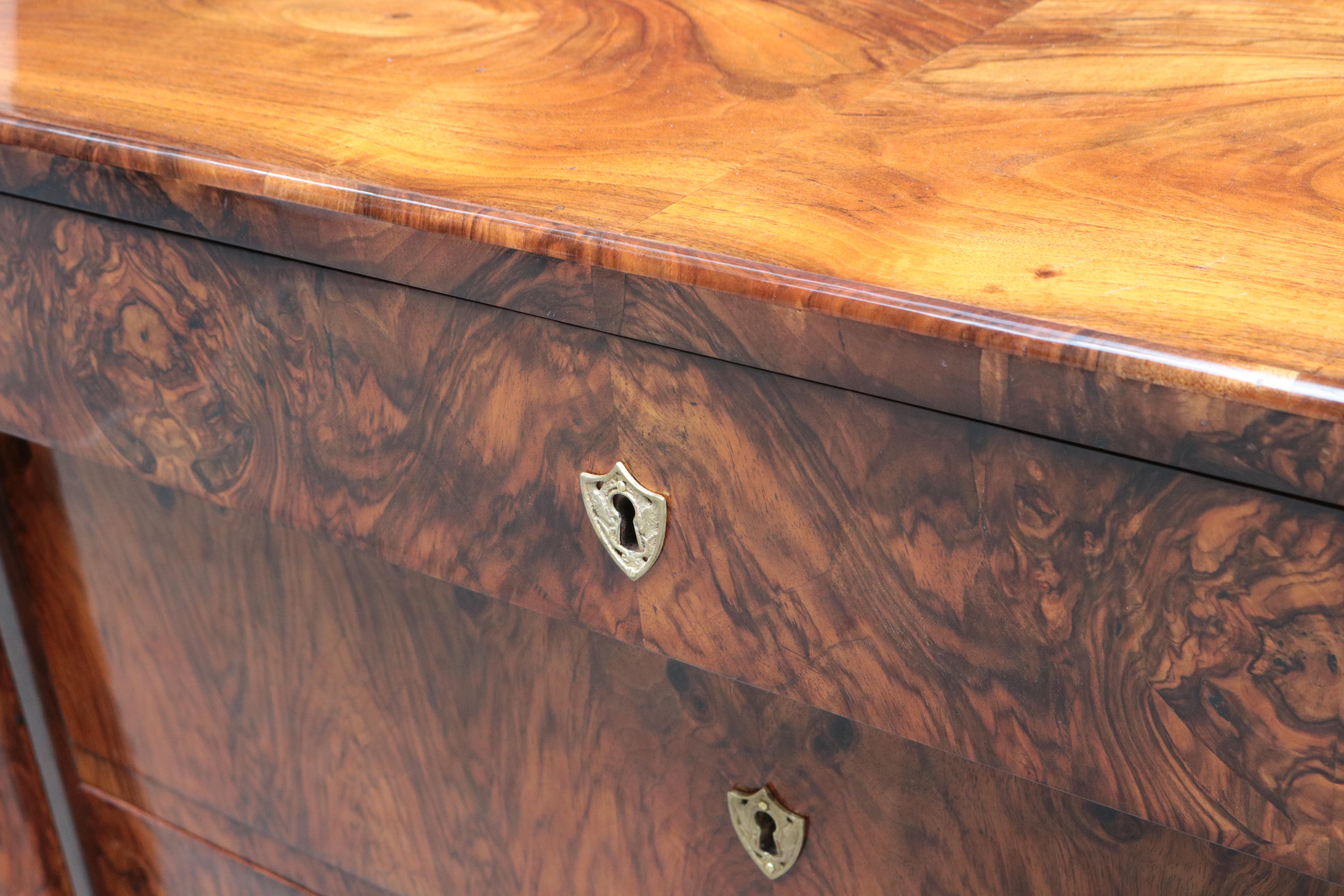 A fine single Biedermeier chest of drawers. 
Walnut with patinated brass escutcheons.