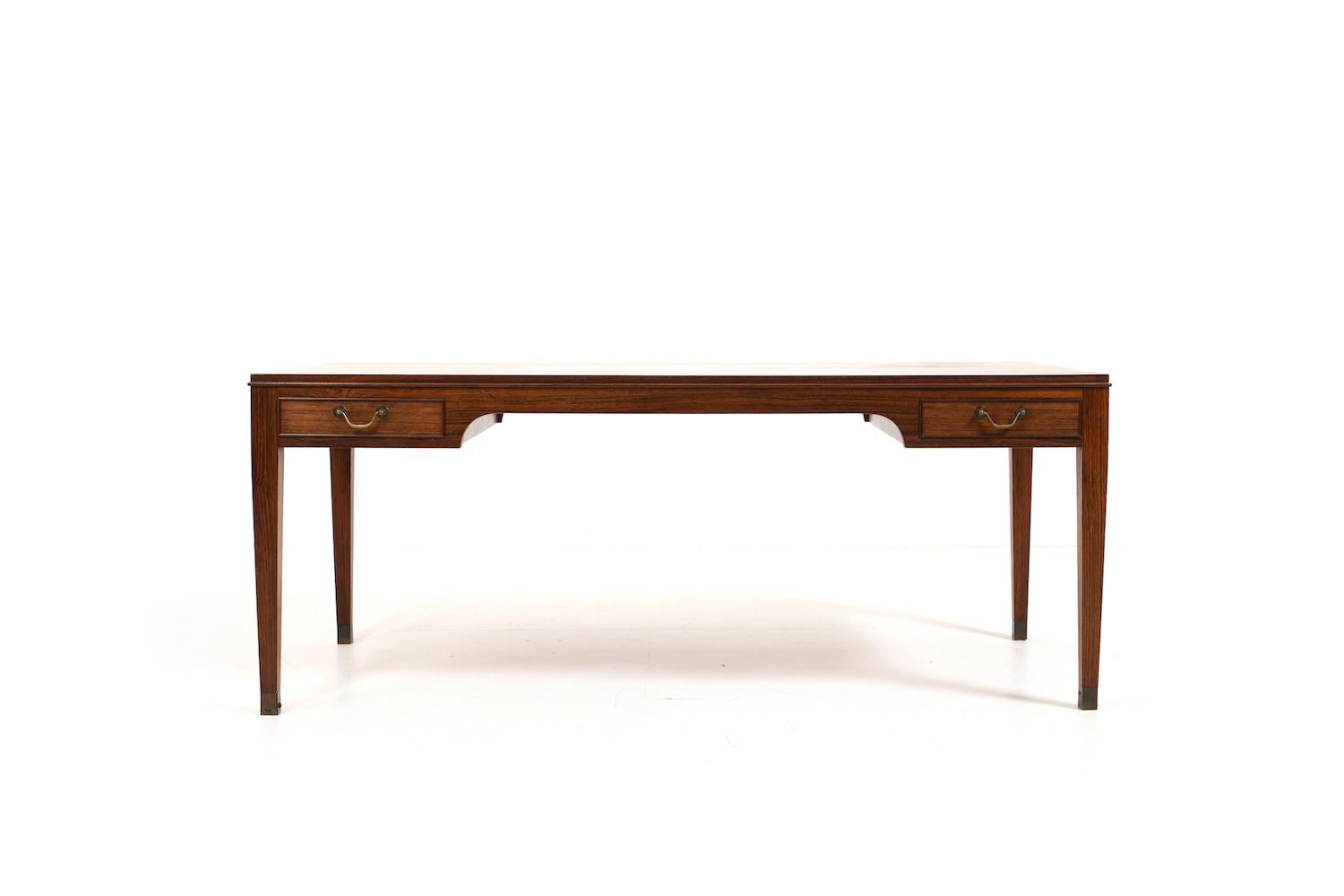 Fine sofa table with 4 drawers (2 each side) and brass shoes and handles. Produced by the famous danish cabinetmaker Frits Henningsen, Copenhagen Denmark. Made in finest wood and quality. 1940s