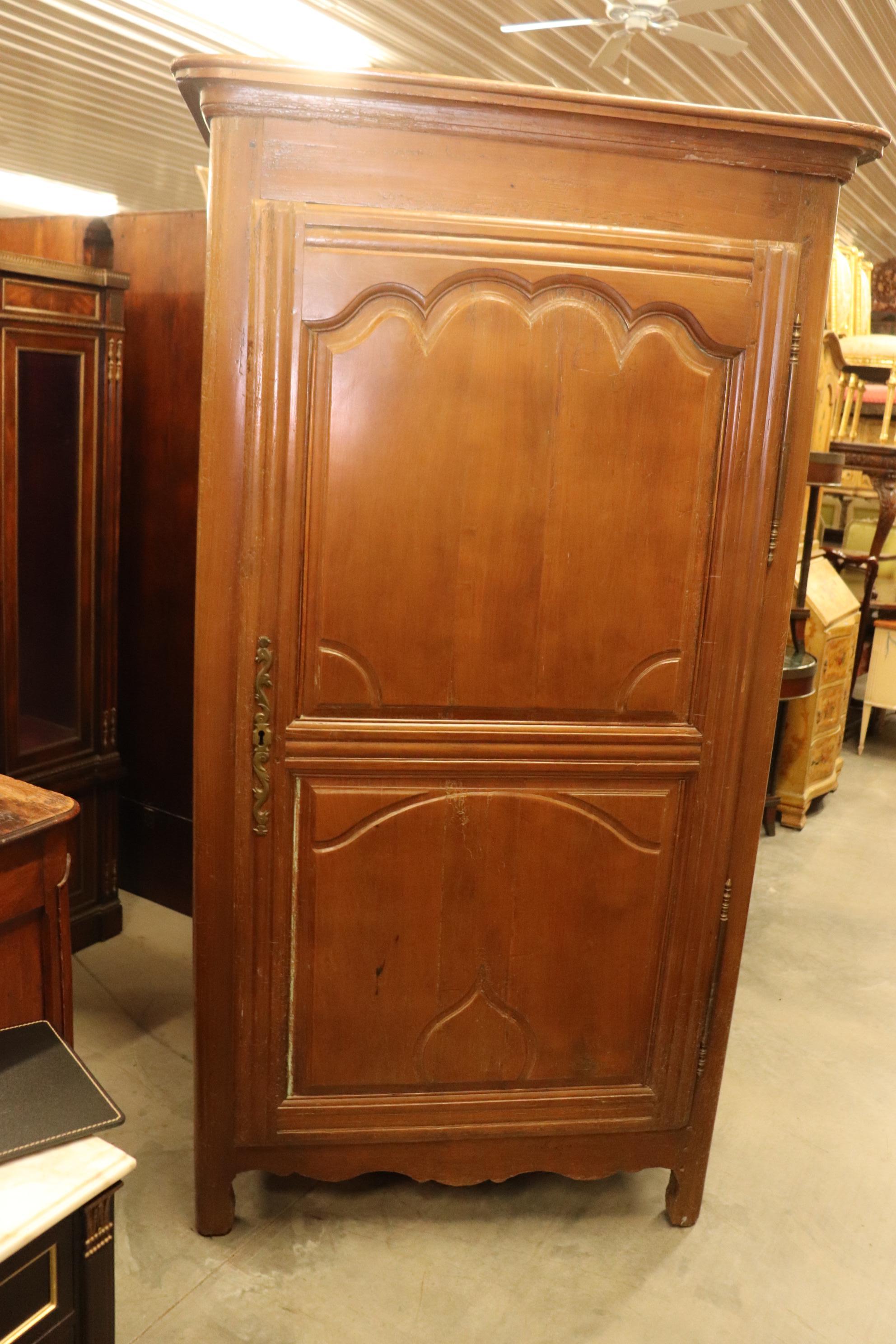 This is a gorgeous solid oak French bonnetiere or single door armoire. The armoire has all of the desirable features most collectors yearn for, worming, an old lock and a beautiful hand-hewn interior. The armoire measures 76 tall x 23.5 inches deep