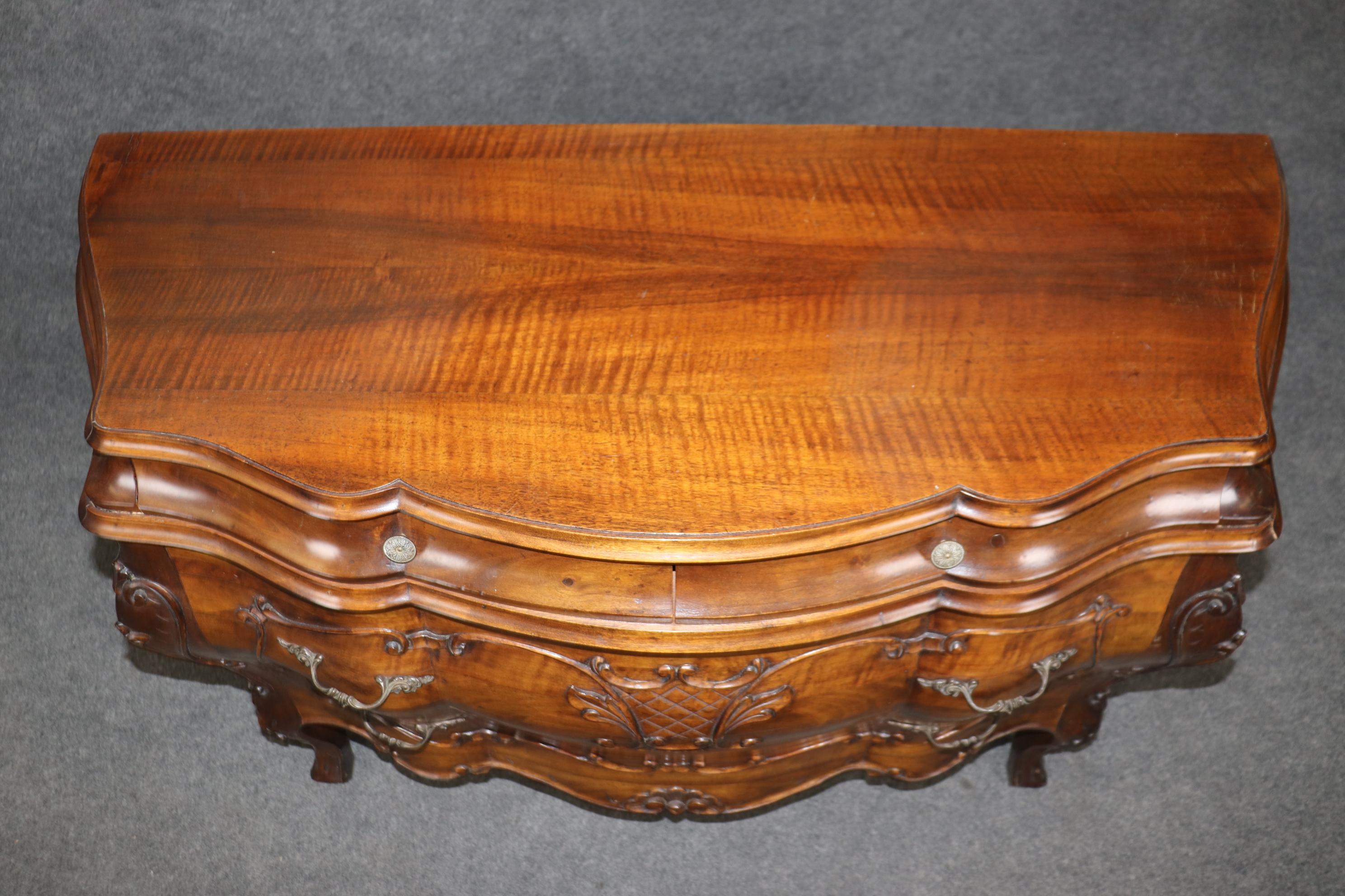 This is a gorgeous solid walnut commode made in Italy but in the tradition of French Louis XV style. The Commode shows minor signs of age and minor age cracks from age but nothing significant. Measures 50 wide x 33 tall x 19.5 deep. dates to the
