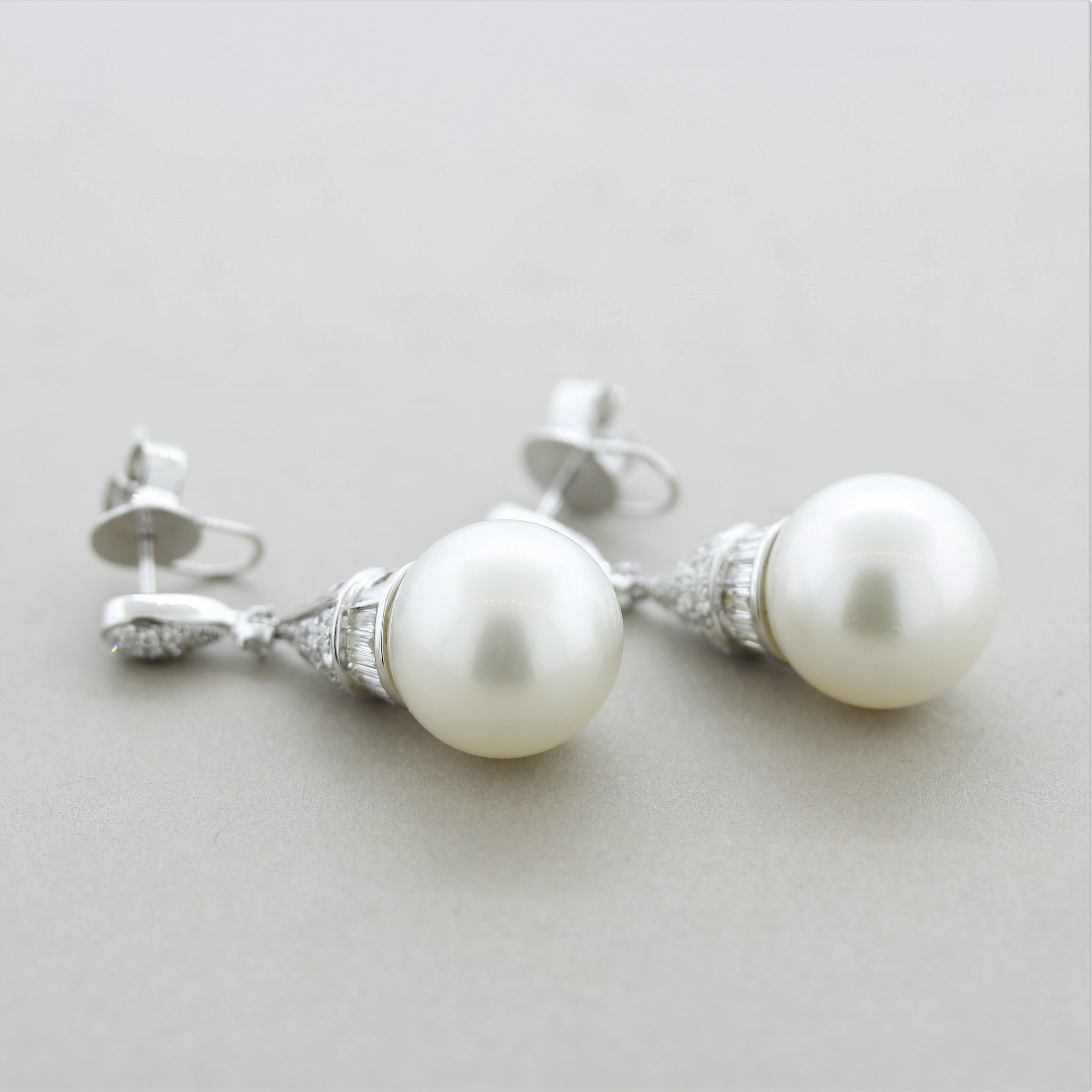 A fun, chic, and stylish pair of South Sea pearl earrings! The pearls are perfectly matching in size (13mm), shape, and color as they both are blemish free and have an excellent luster as light rows across their surfaces. They are accented by 1.04