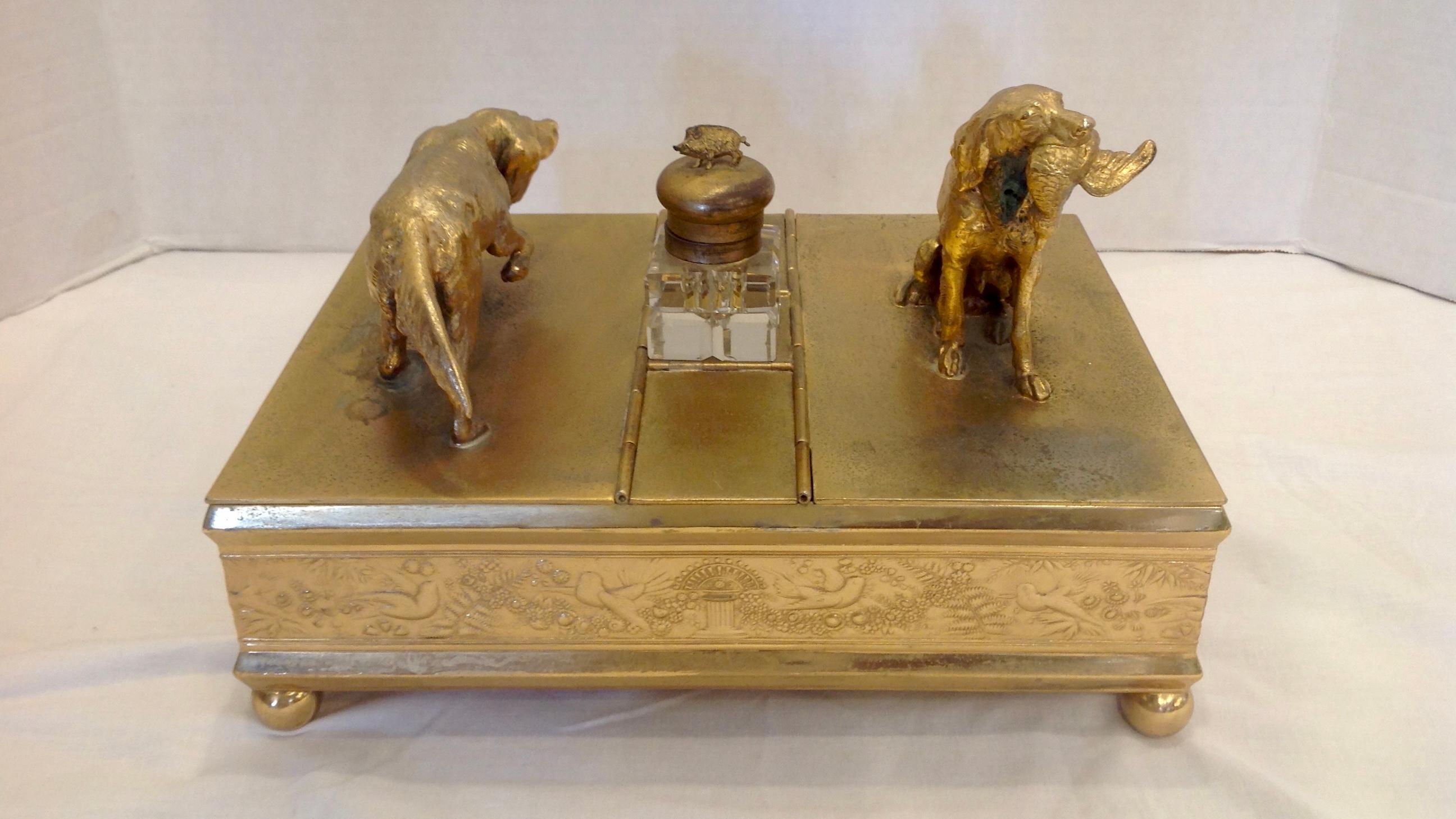 Gilt metal appointed with hunting dogs, one holding waterfowl in his mouth,
the other prowling. The inkwell lid is adorned with a boar.
Maid by Meridan, Connecticut in the 1890s.