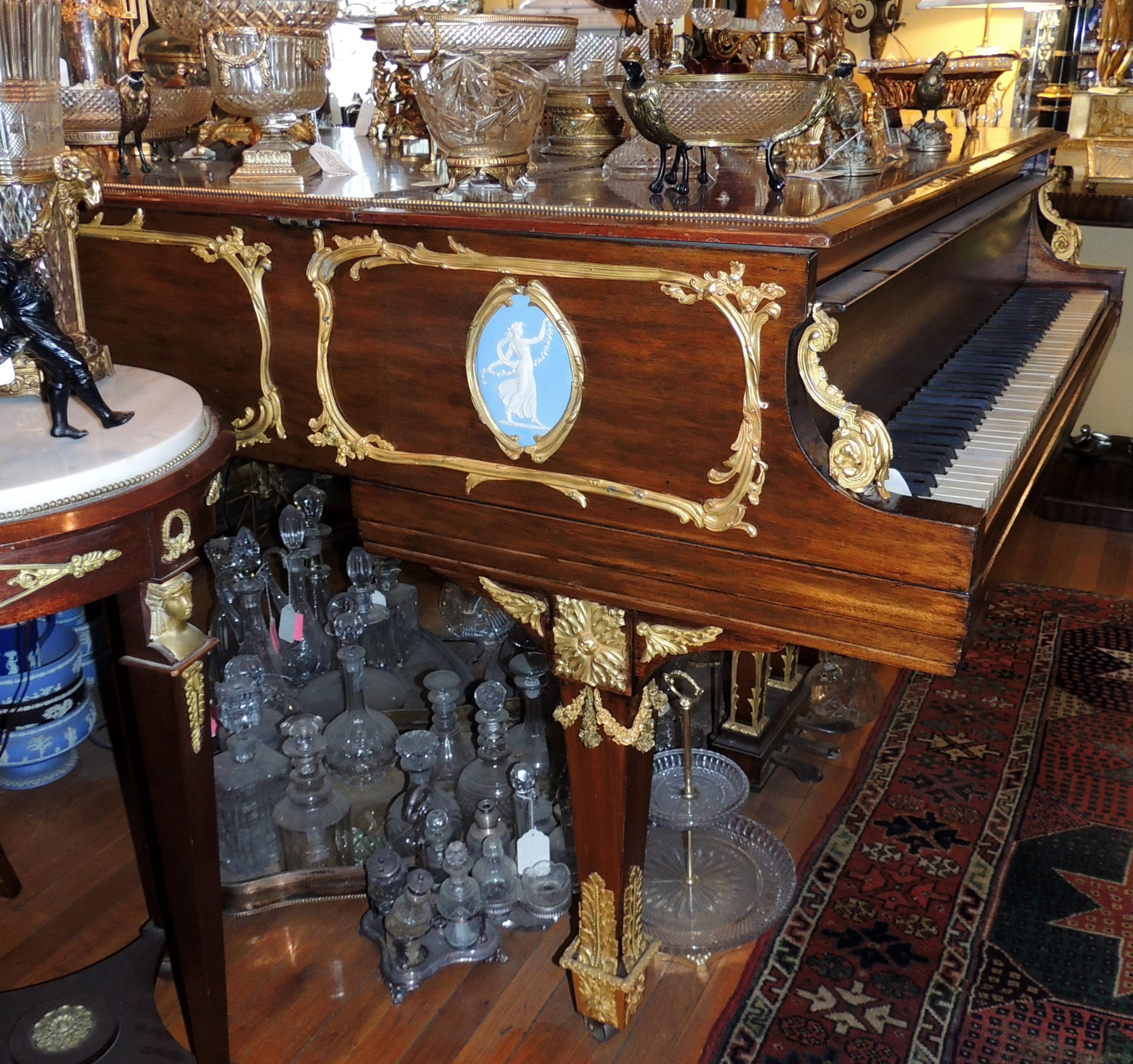 Steinway & Sons Ormolu Mounted Mahogany Baby Grand Piano
Model M, serial no. 244684, circa 1926
With Wedgwood Light Blue Jasperware / Wedgwood Framed Oval Plaques Decorated With Classical Female Figures In White Cameo Relief. 
Length 65 1/2 inches.