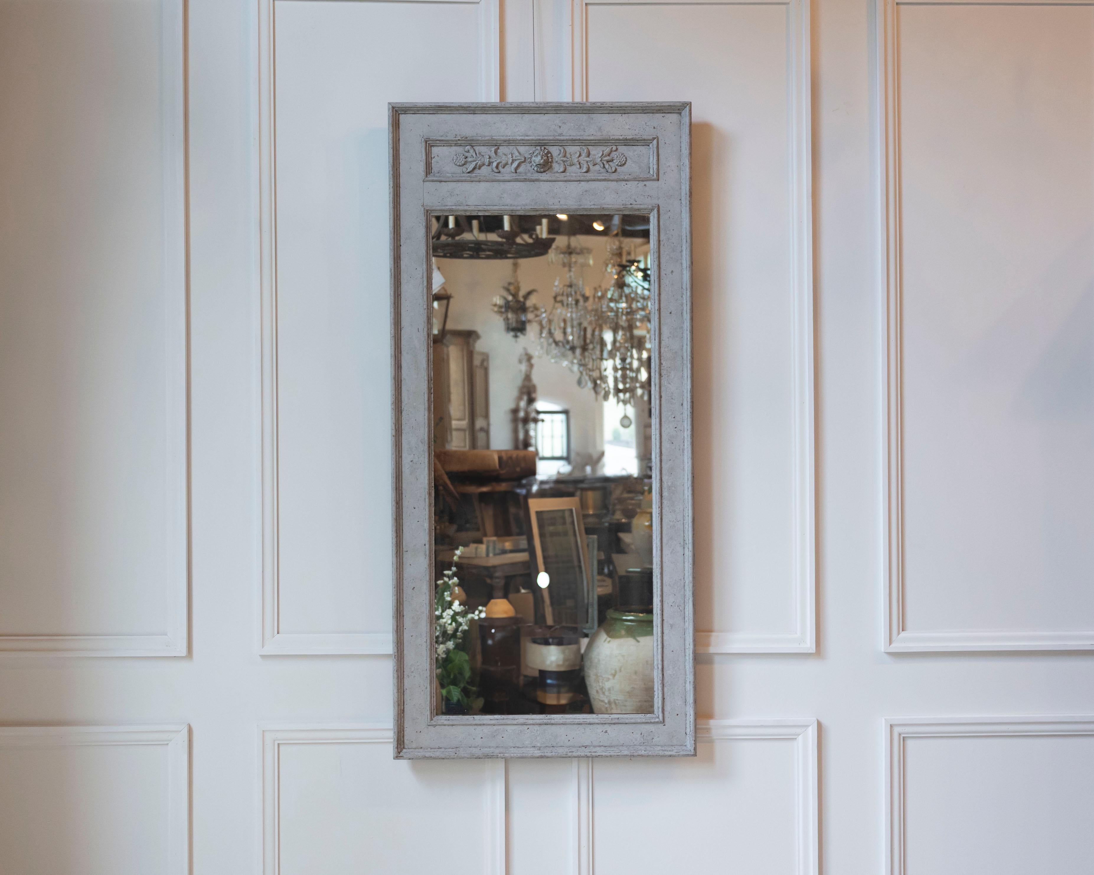 A fine Swedish mirror of exceptional quality, dating to circa 1870. The rectangular frame is finished in a soft Gustavian gray, its surface enriched by a gentle, time-earned patina that enhances the piece’s historic charm. The upper frieze is