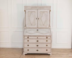 Fine Swedish three-part bureau with charming carvings and marble-painted columns