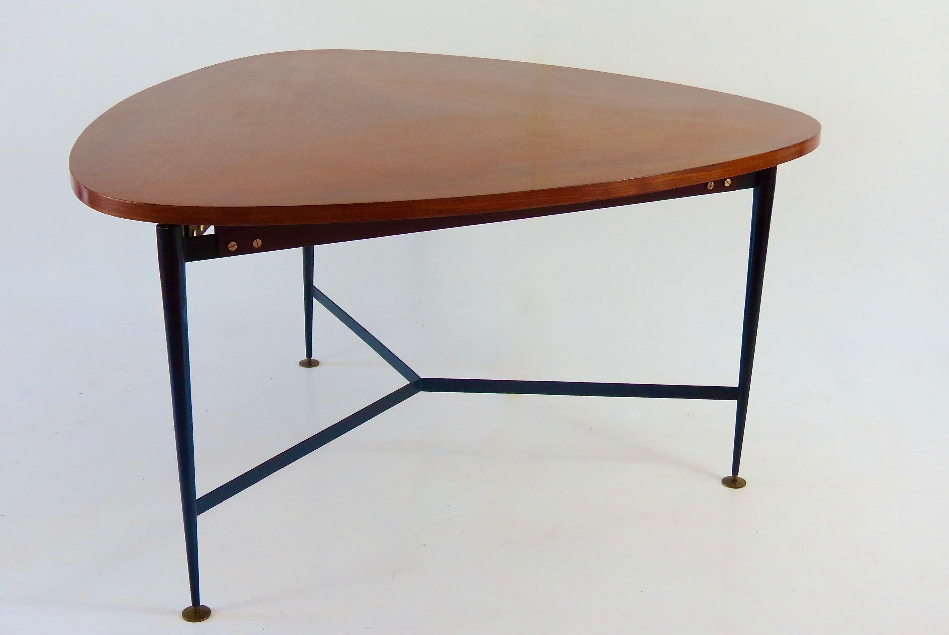 rare large dining or center table by Silvio Cavatorta circa 1950 
three feet and triangular top rounded on the sides
elegant thick top and fine sunburst veneer 
beautiful details on the brass screws and feet 
black lacquered iron, teak and brass