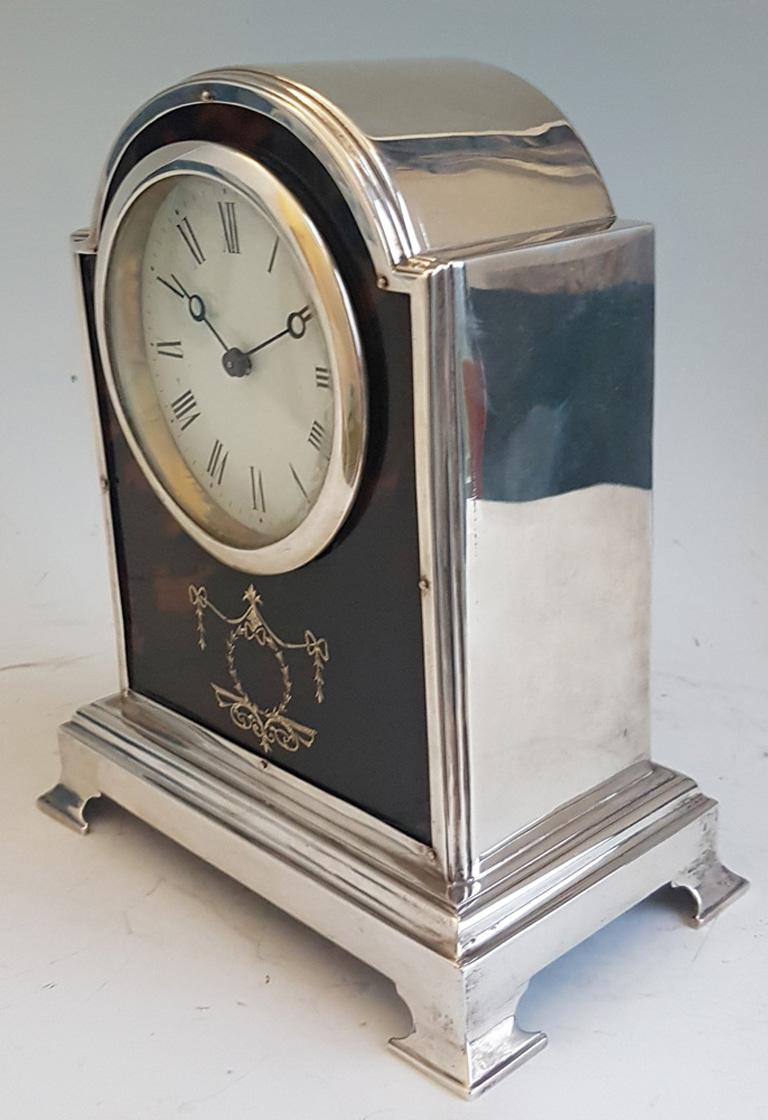 A very fine tortoiseshell and silver pique mantel clock by Henry Matthews. A lovely case set on four silver feet with pique wreath work around the bottom of the case which has plain silver sides. The front however is of blond tortoiseshell with