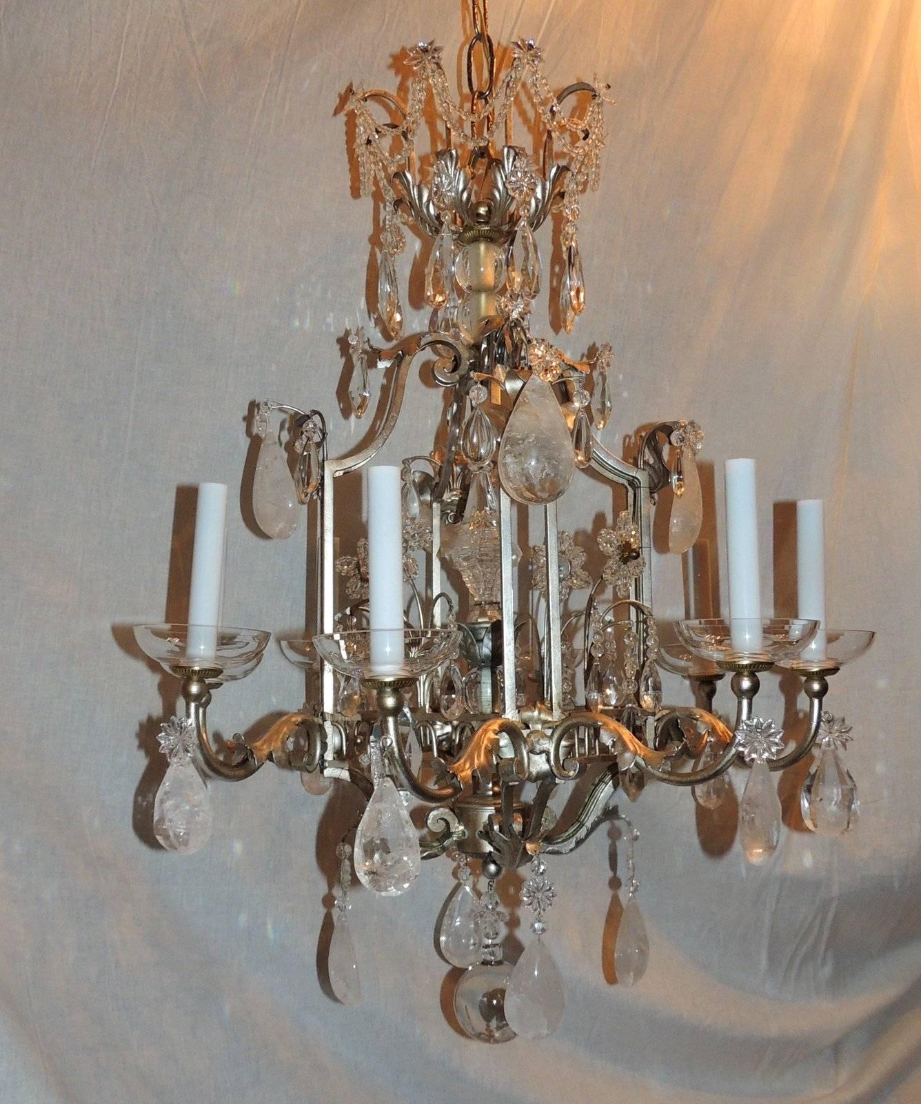 This is a fabulous and unusual pagoda form chandelier that has a beautiful crown with draped crystals and beading. Each of the eight scrolled arms have a crystal flower from which hangs a rock crystal. The chandelier is finished with a rock crystal
