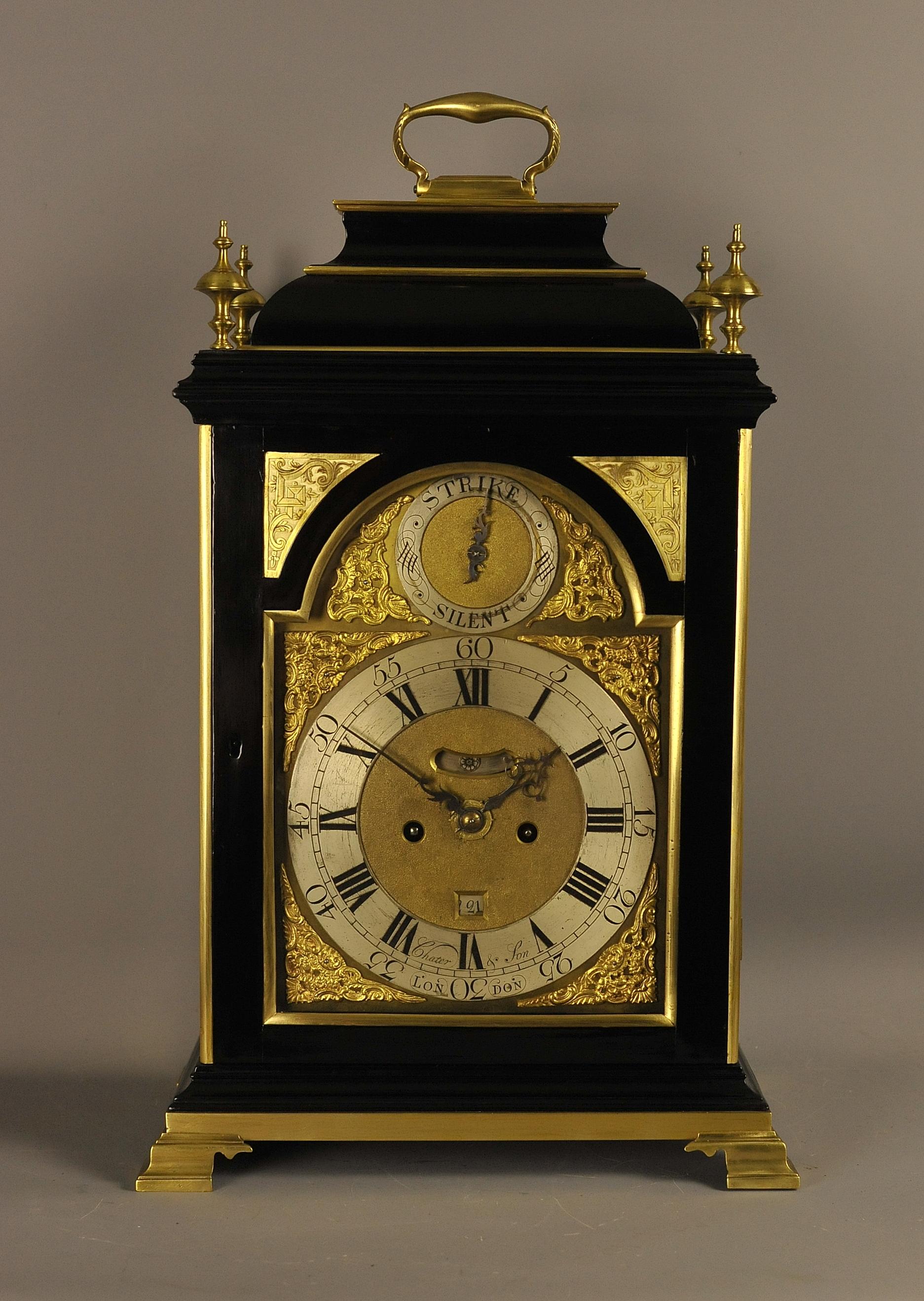 This is a very fine and impressive gilt brass mounted verge bracket clock by Chater and Son , London circa 1760 .
William Chater (1) was apprenticed in 1718 and made a member of the Clockmakers Company in 1726 and died in 1762. He took his son ,