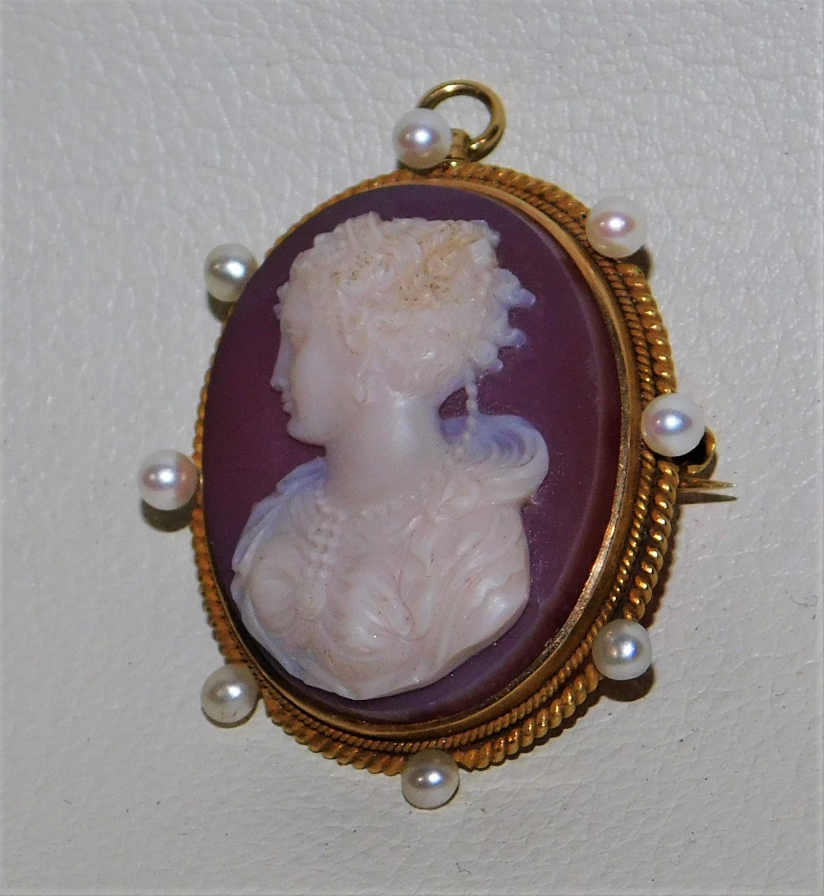 This is a vintage 19th century stamped 14kt hard stone agate hand carved cameo brooch/pendant.  It is centrally set with an oval hand carved banded agate cameo featuring a young maiden with eight pearls and is set in a hand etched 14k yellow gold