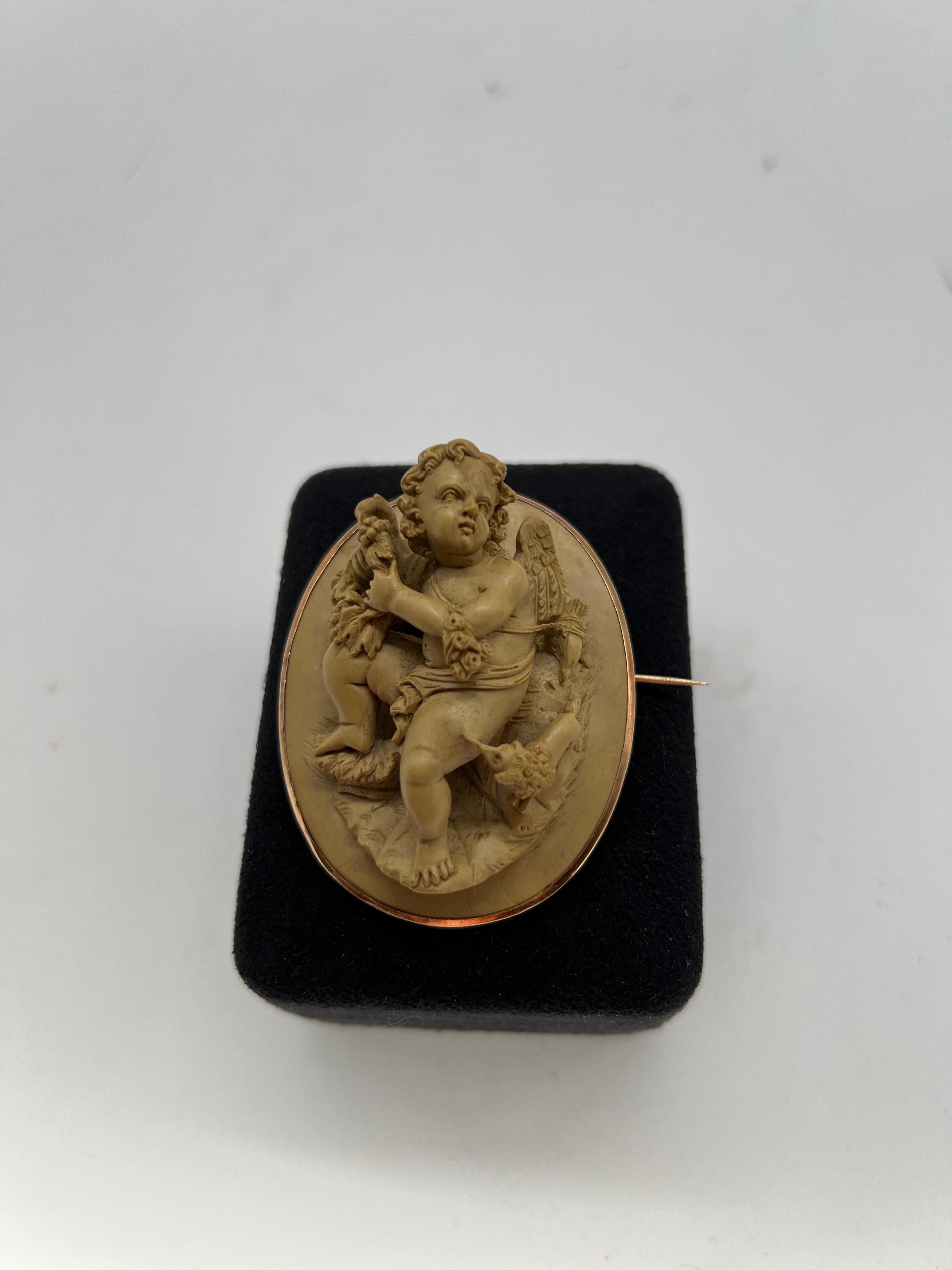 Or Broche victorienne de putti et chien en or jaune 18 carats et pierre de lave sculptée en vente