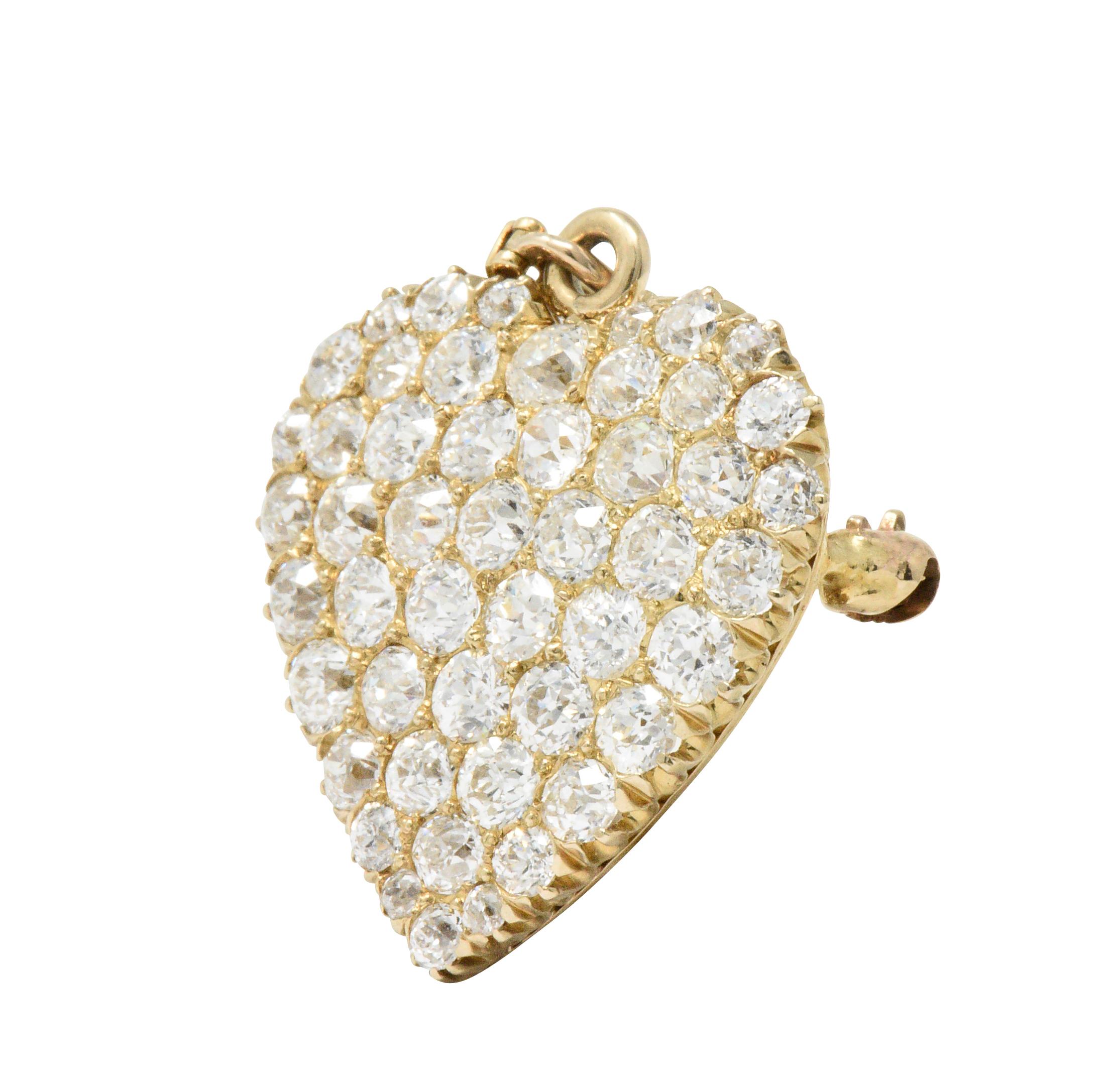 Heart with pavé set old European cut diamonds, weighing approximately 3.50 carats total, G/H color, VS to SI clarity

Featuring a pin stem and diamond set bail

Tested as 14 karat gold and numbered

Delightfully romantic with versatility of