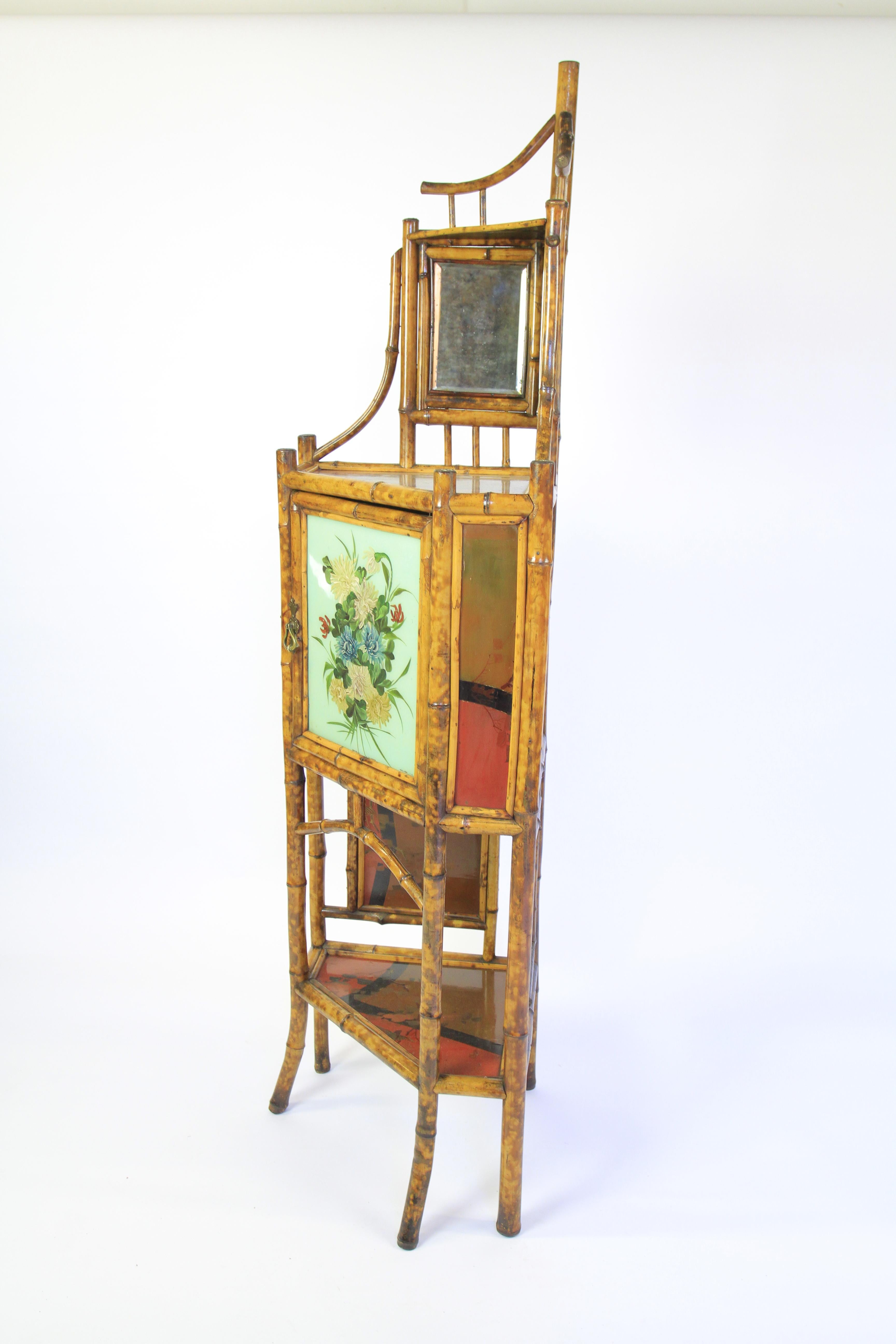 Fine Victorian Bamboo & Laquered panel Corner Cupboard
top with Bamboo frame with pair inset mirrors, 
Brass turn catch to open Centre Door with painted Floral Decoration, 
Laquered Decorated Panels on each top of shelves,
Each side of door.