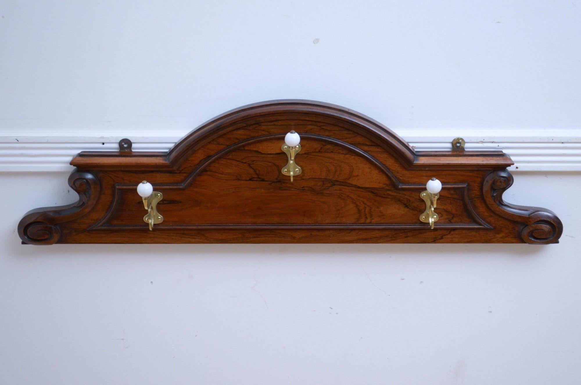 P0295 Fine quality and very attractive Victorian wall mounted coat rack with three shaped brass and porcelain hooks on arched and moulded rosewood backing with decorative scrolls to each side. This antique coat rack is in home ready condition.