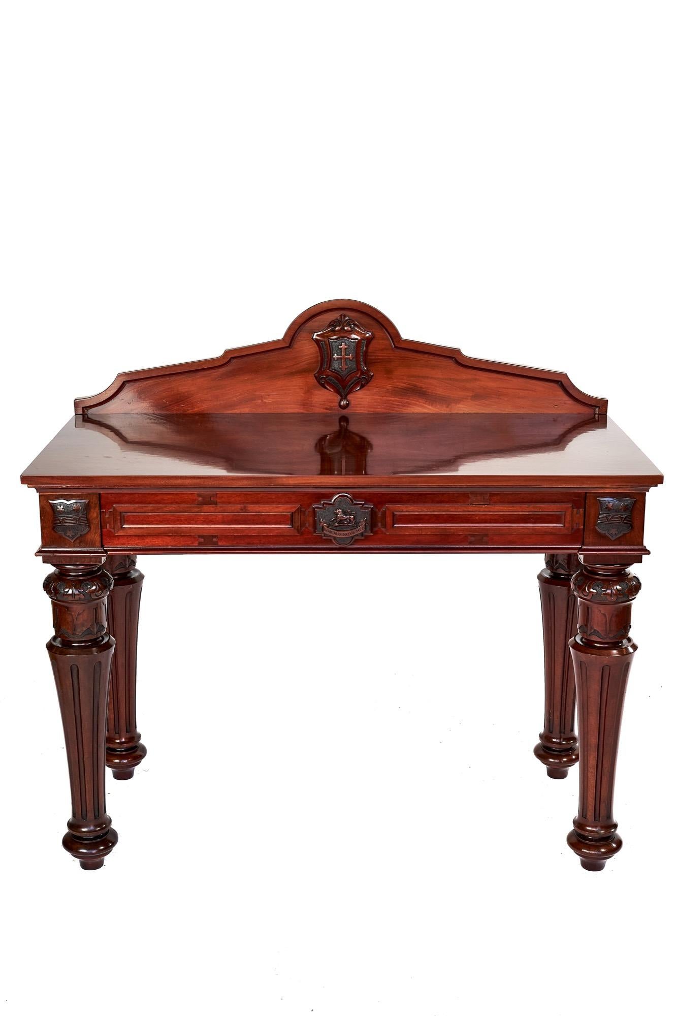 Fine Mid Victorian Mahogany Hall /serving table with Armorial shields,
Shield with  carved cross on back upstand,
Single centre drawer, with centre shield with carved lion and Dominus : Salus: Mea,
Pair shields each side over front legs, 
All