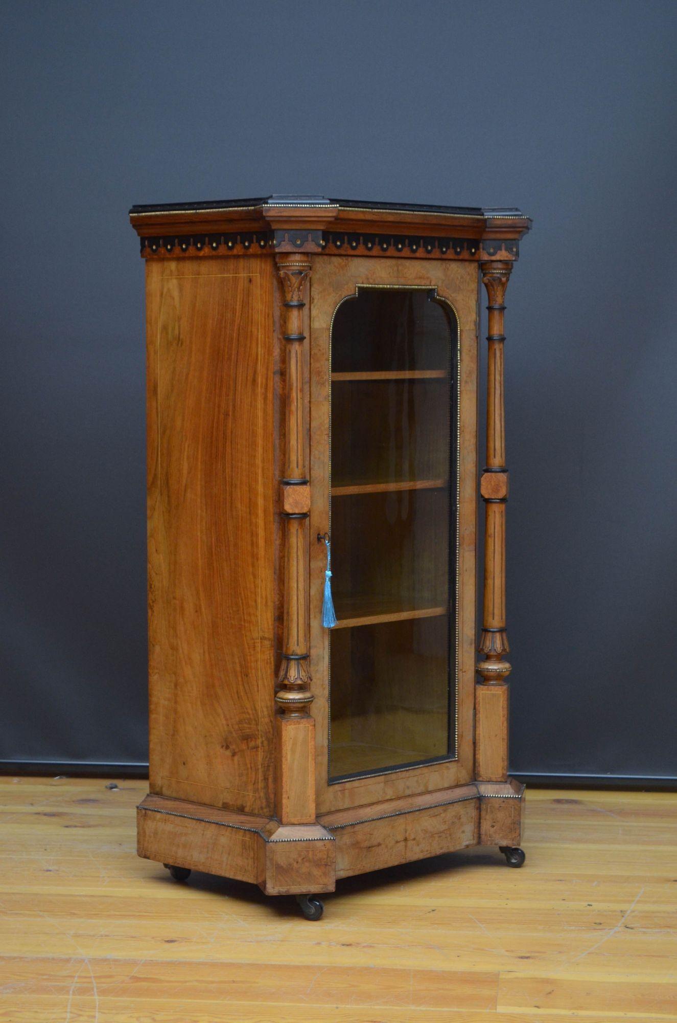 Sn5490 Victorian walnut music cabinet / side cabinet, having burr walnut top with carved and ebonised edge above a decorative frieze and single glass door fitted with original working lock and a key, enclosing three shelves, all flanked by carved,