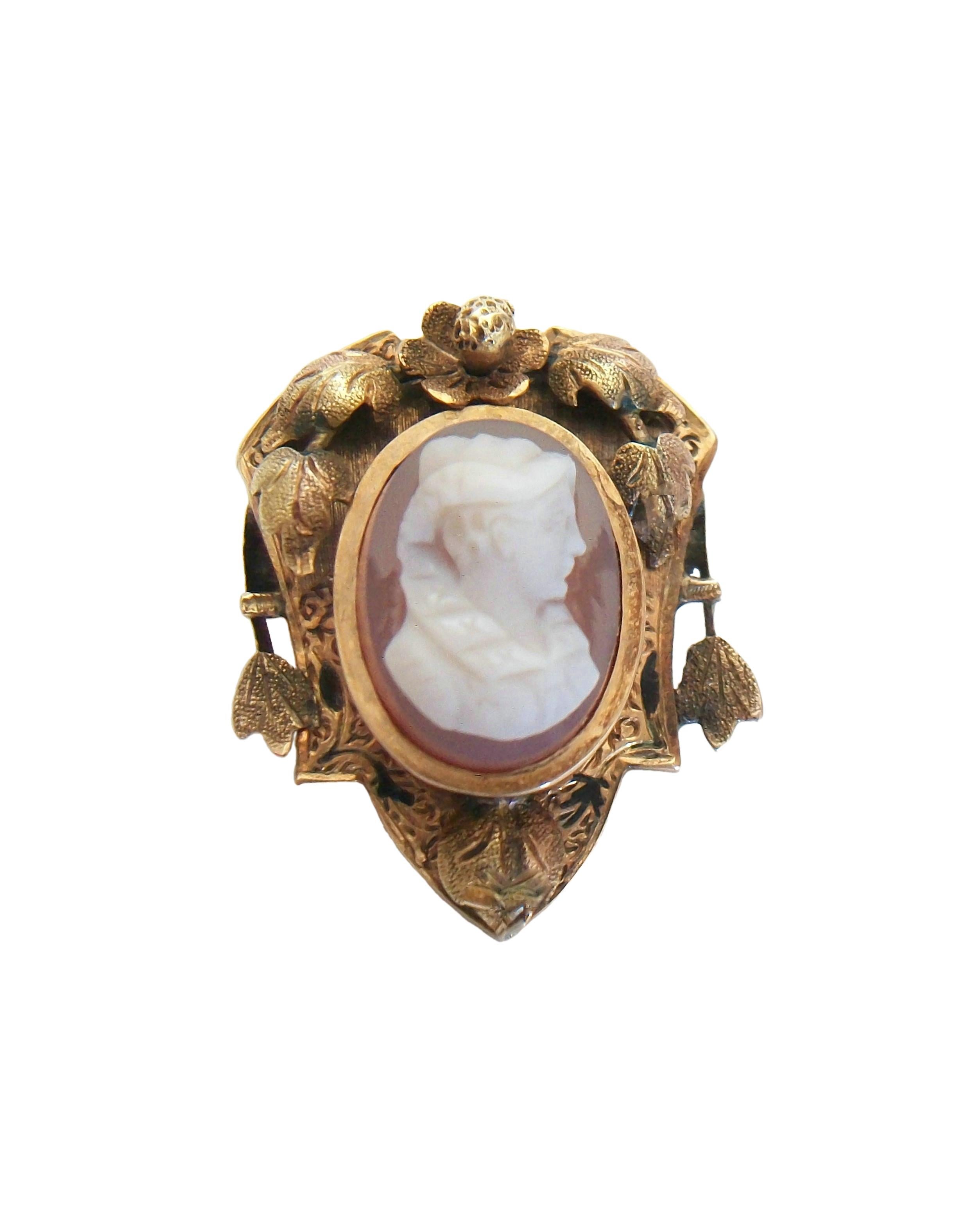 Antique Victorian Sardonyx hardstone (Chalcedony Quartz) cameo brooch / pin - the cameo hand carved with fine detail and set in an elaborate tooled 10K yellow gold frame - featuring a profile of a woman (possibly Queen Victoria) - the gold frame