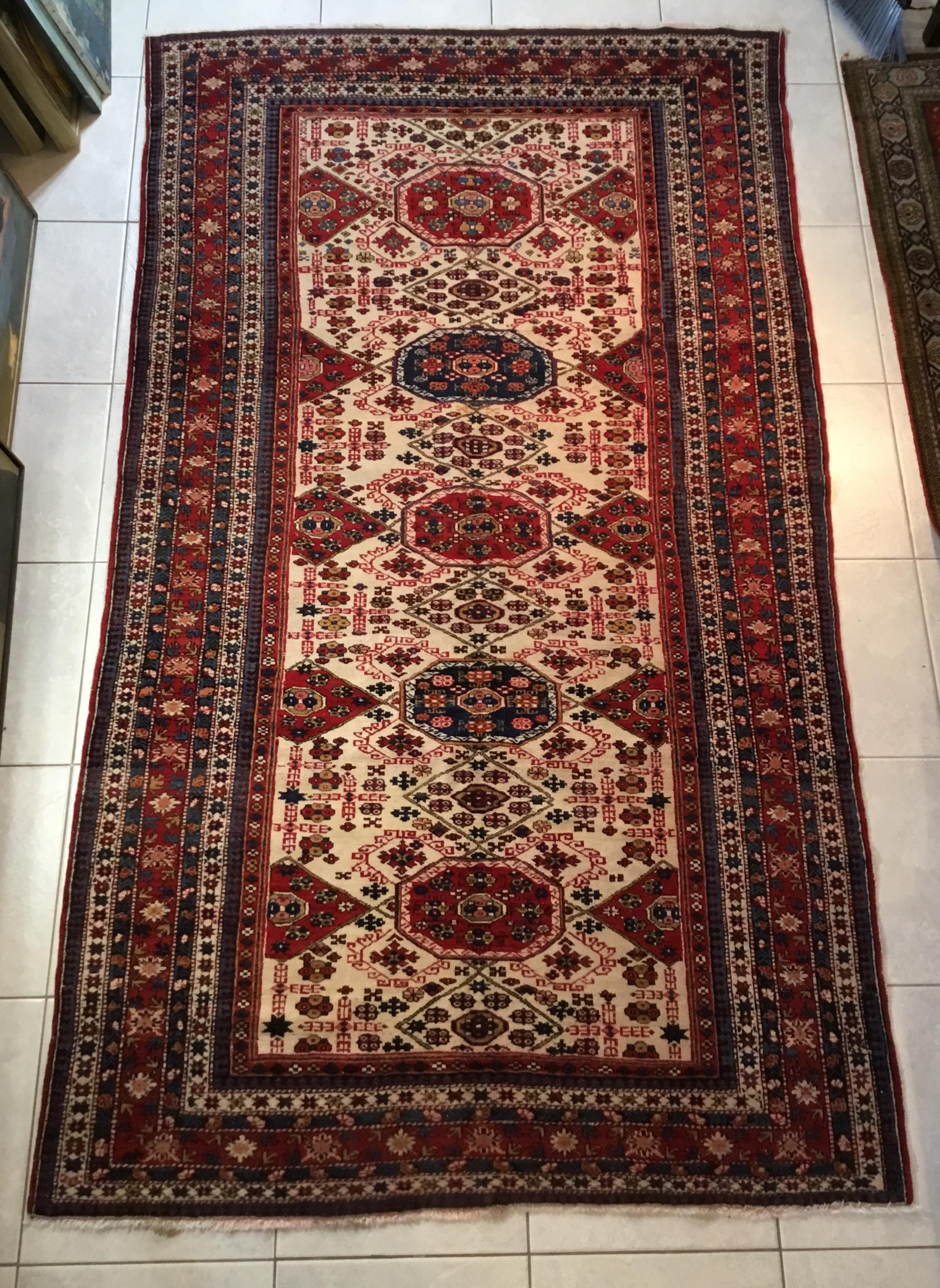 Fantastic Caucasian rug made of wool with beautiful all over motifs of ram's horn, vertical and horizontal geometric motifs, five octagons in the centre with repeated geometric motifs of flowers , All surround with eight outstanding borders. The rug