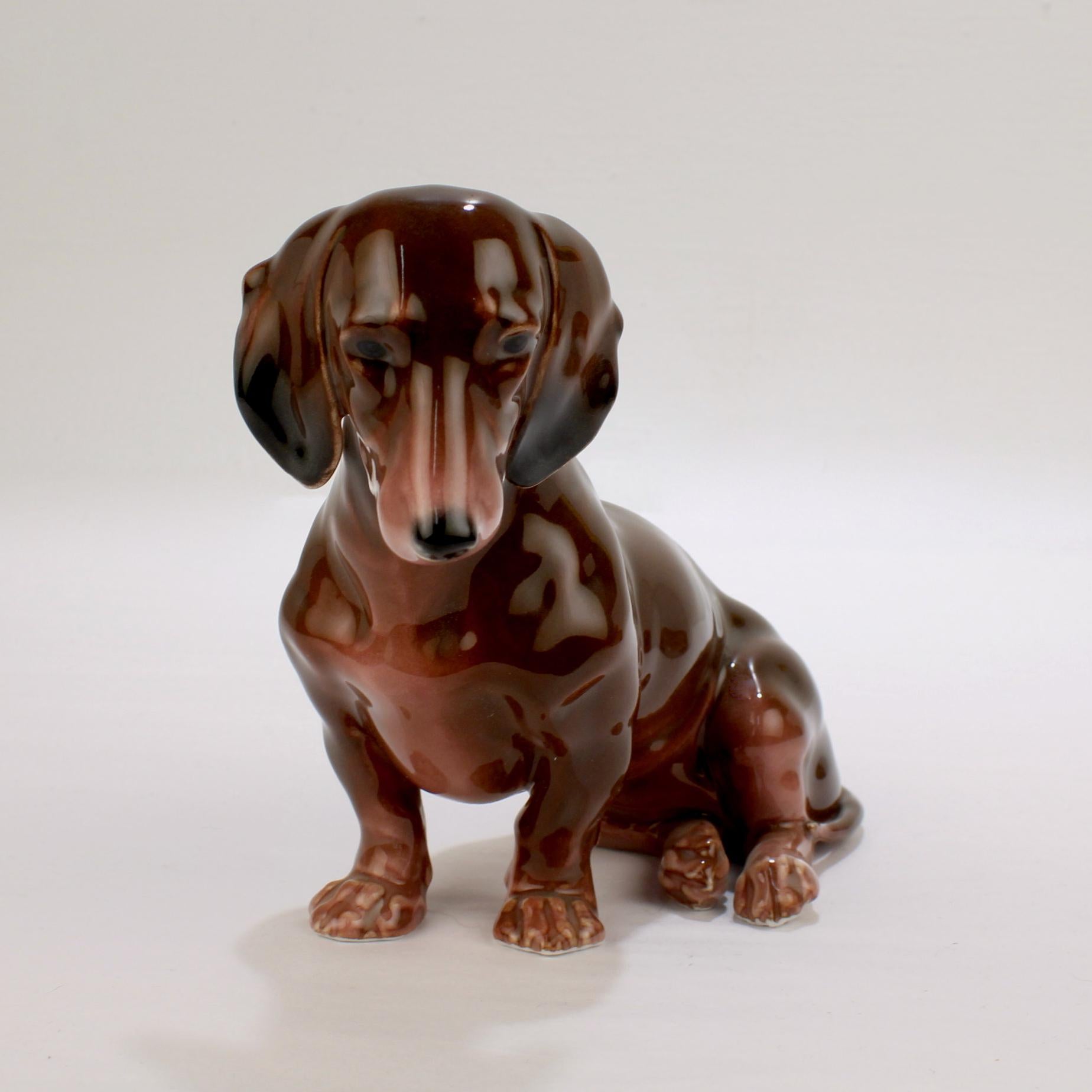 Offered here for your consideration is a wonderful Karl Ens porcelain figurine.

Modeled as a seated Dachshund dog. 

Decorated principally in brown tones with black and white features. 

Model no. 2578.

The Karl Ens factory was a