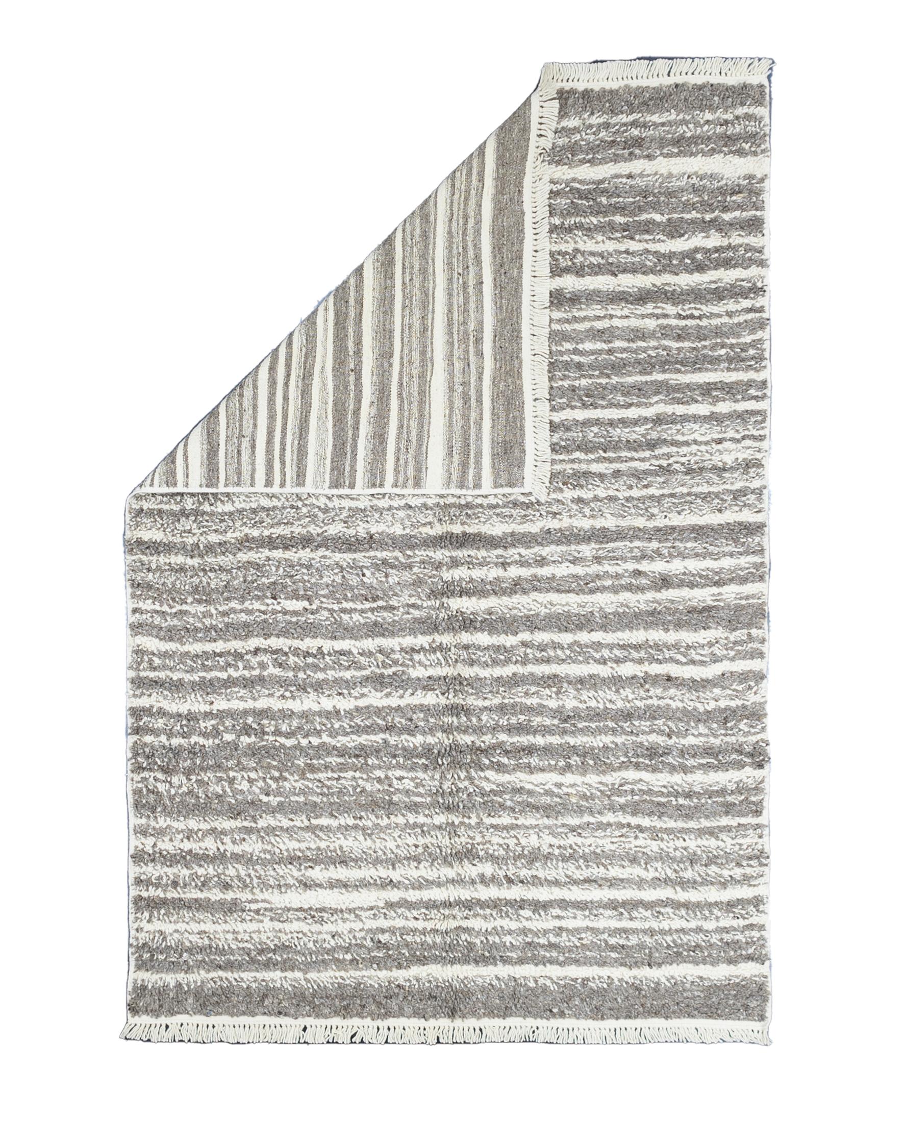 Fine Vintage Moroccan Wool Rug 5’5” x 8’2”. Comprising both the nomadic Berber rugs of the Atlas Mountains, with very thick piles, coarse knotting and limited palettes, and the more colorful, coarse to moderate rugs woven around Rabat, often with