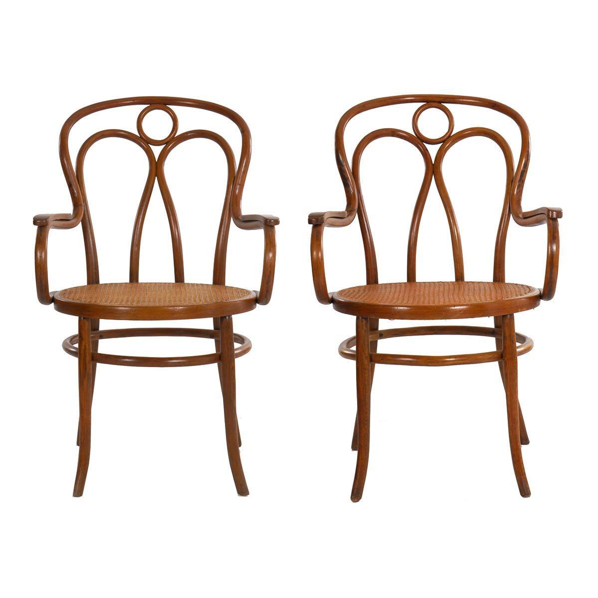 A fine pair of late 19th to early 20th century arm chairs designed by Josef Kohn and manufactured by the firm of Josef Jaworek, one still retaining the original label to the underside, these were offered as no. 36 in his catalogue and are a quite
