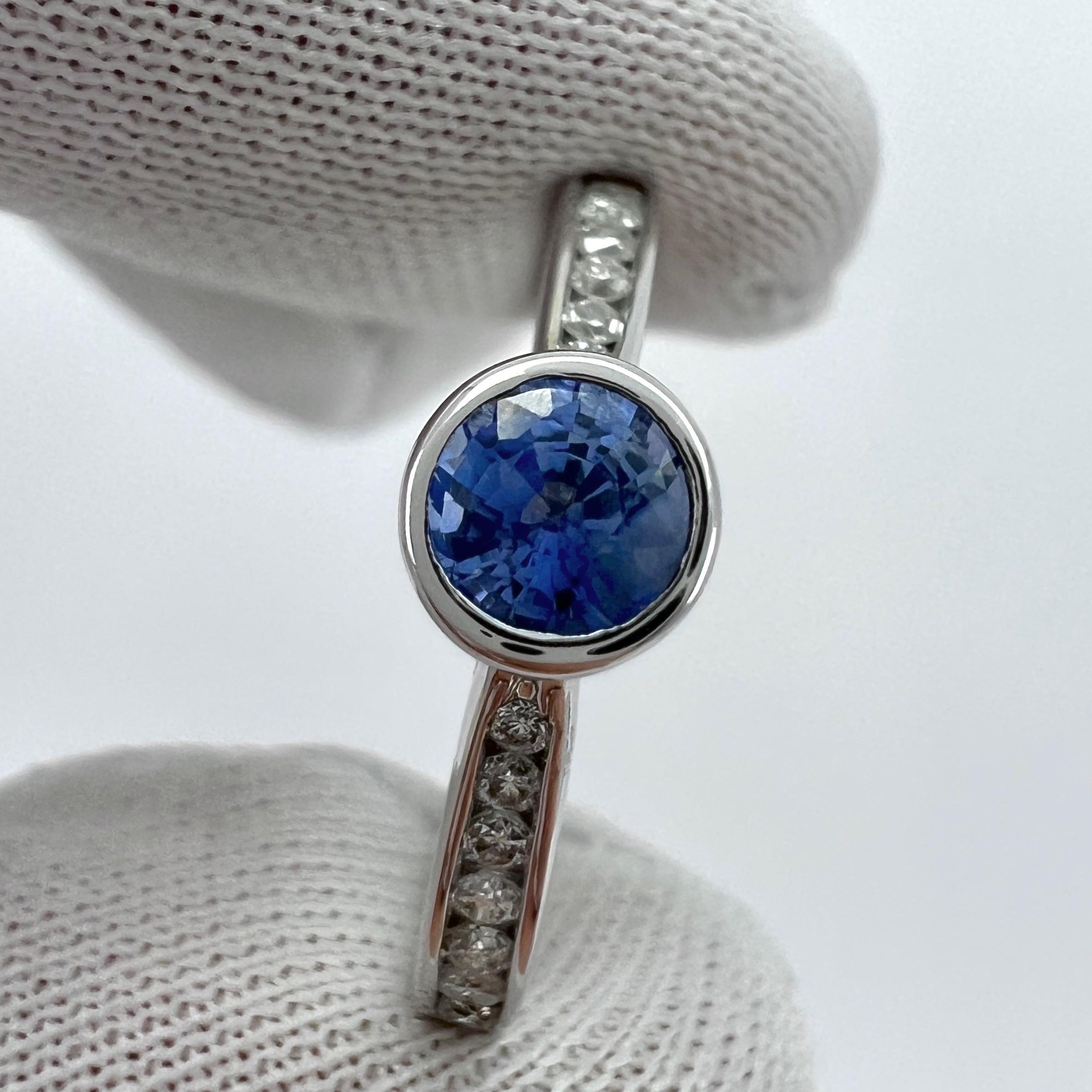 Vivid Light Blue Round Cut Natural Ceylon Sapphire And Diamond White Gold Bezel Rubover Ring.

0.60 Carat total. This ring features a beautiful vivid light blue Ceylon sapphire stone with a bright blue colour and excellent cut and good clarity. Some