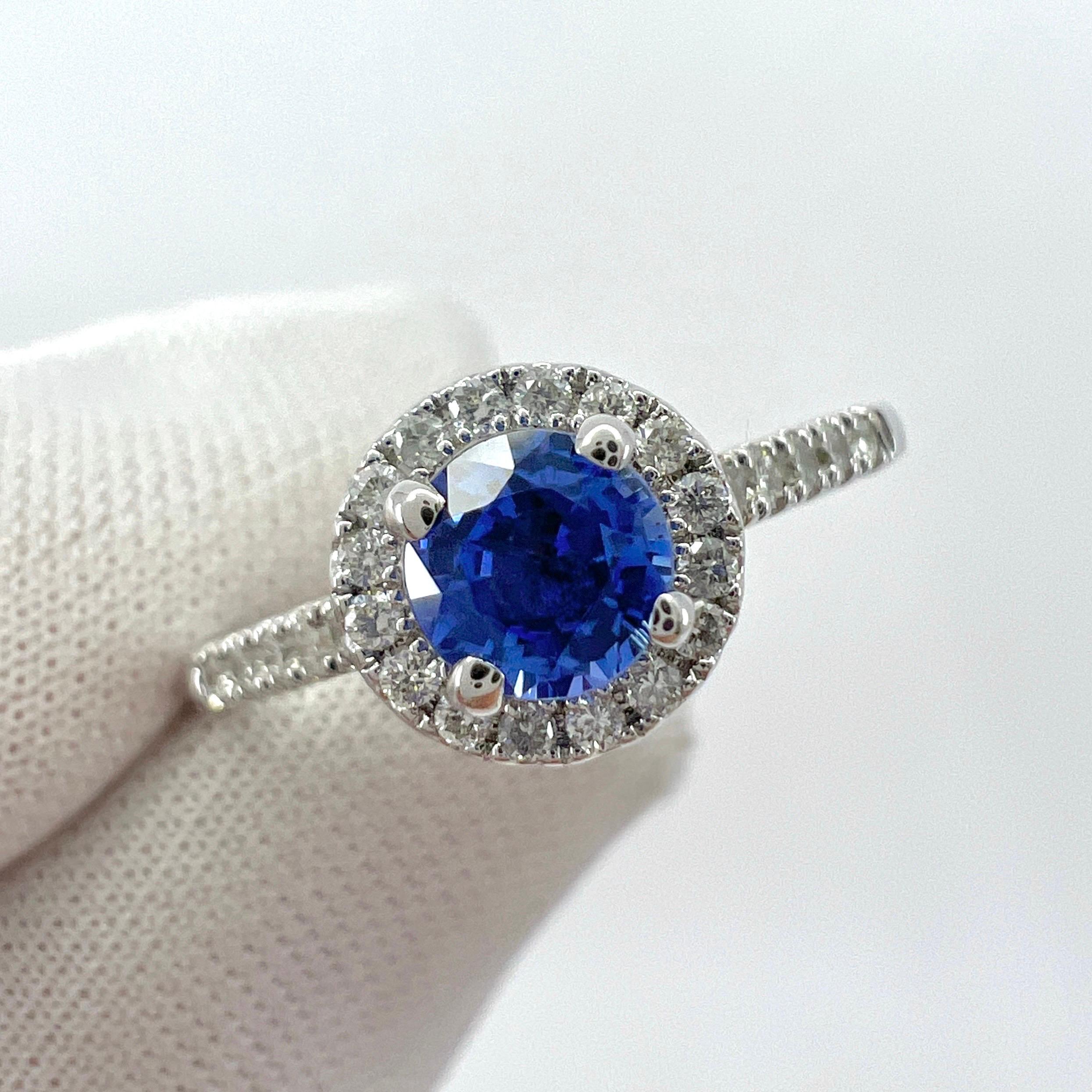 Fine Vivid Blue Round Cut Natural Ceylon Sapphire And Diamond White Gold Halo Ring.

0.75 Carat total. This ring features a beautiful vivid blue Ceylon sapphire centre stone with a fine blue colour and excellent cut and clarity. The sapphire