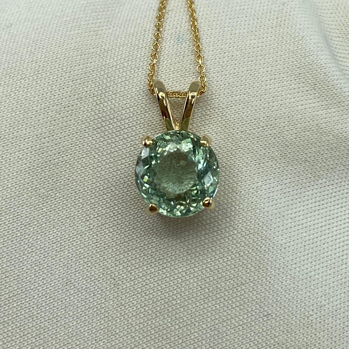 Fine Natural Green Blue Aquamarine Pendant Necklace.

2.50 Carat Aquamarine with a stunning vivid green blue colour set in a fine 14k yellow gold solitaire pendant.
The aquamarine has an excellent round brilliant cut showing lots of brightness and