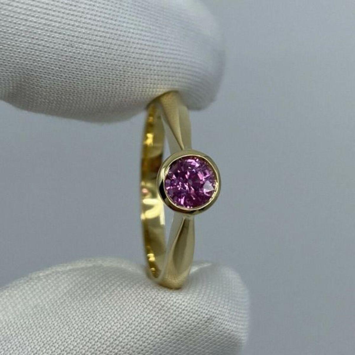 Fine Vivid Pink Sapphire Round Cut 18K Yellow Gold Solitaire Rubover Bezel Ring

Fine Natural Vivid Pink Sapphire 18K Yellow Gold Solitaire Ring. 
0.53 Carat stone with a stunning vivid pink colour and excellent clarity. Very clean stone. Also has