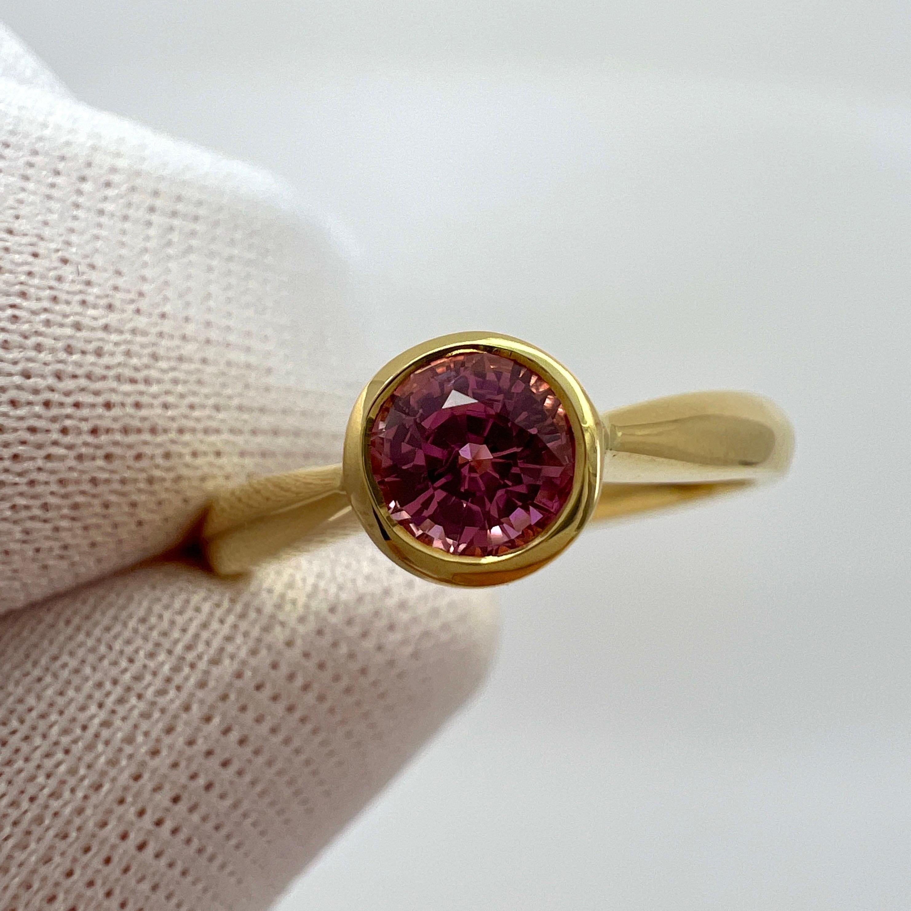 Fine Vivid Pink Natural Sapphire Round Cut 18K Yellow Gold Solitaire Rubover Bezel Ring

0.53 Carat natural sapphire with a stunning vivid pink colour and excellent clarity. Very clean stone. 
Also has an excellent round brilliant cut which shows