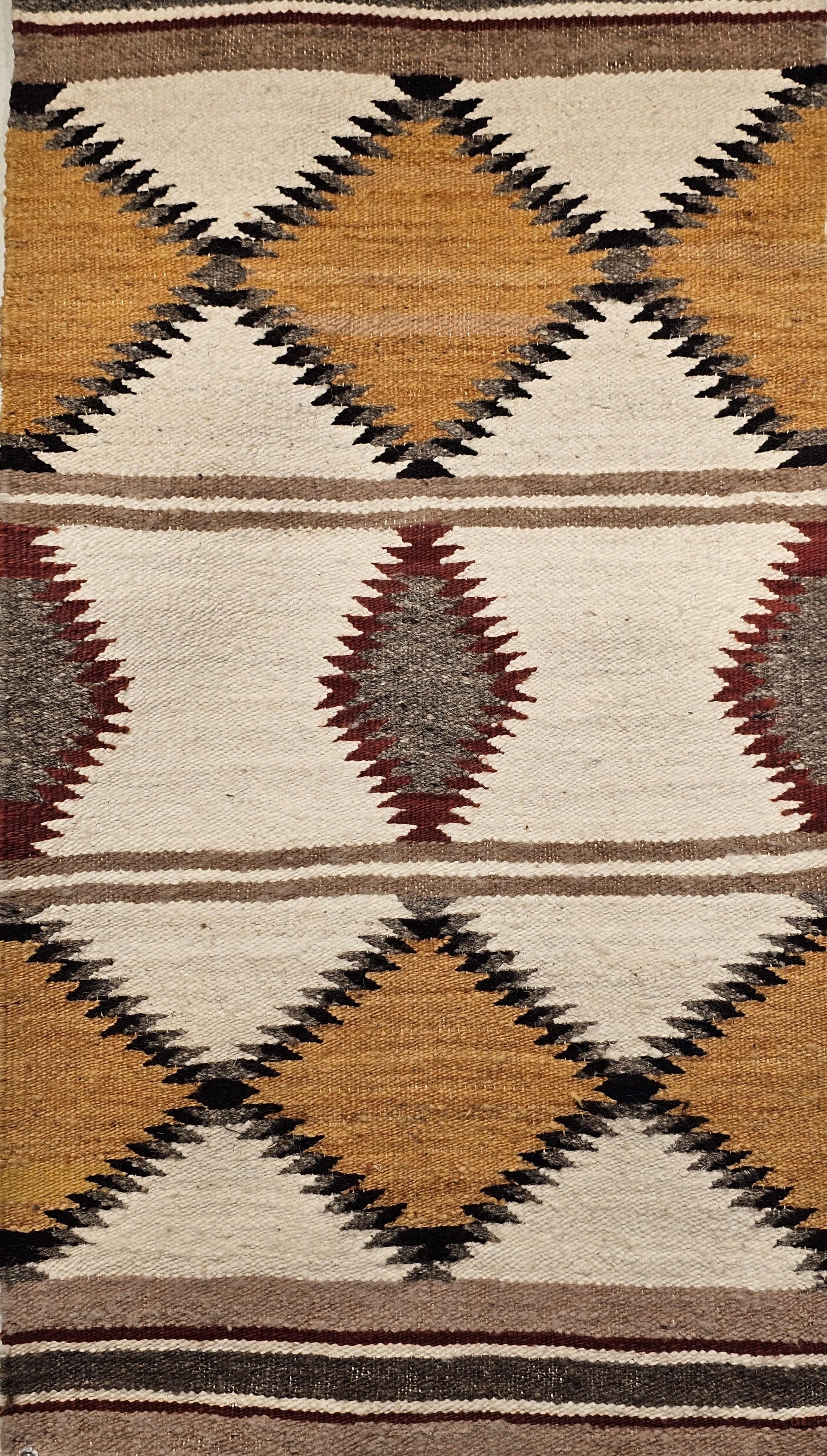 Vintage Native American Navajo area rug in ivory, gray, brown, and black colors from the late 20th century.   The rug has a very fine weave and beautiful design.   Navajo rugs are generally flat woven with wool for the body of the rug and usually