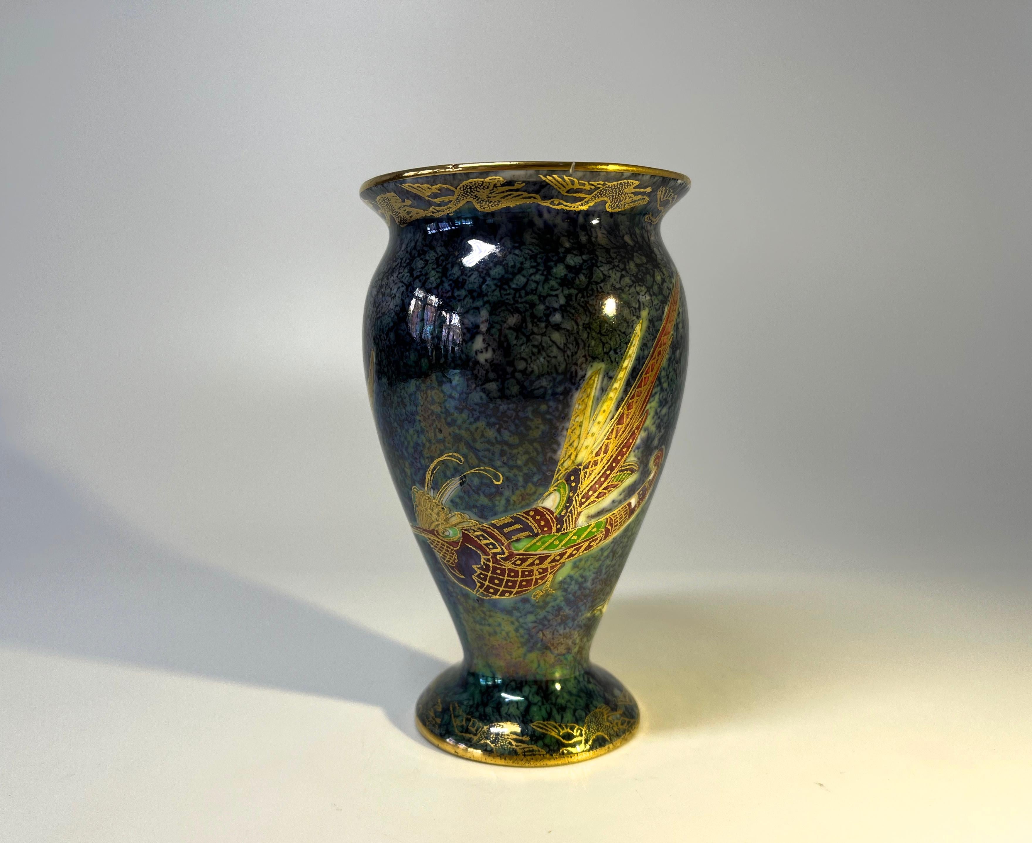Fine quality Wedgwood porcelain baluster vase created by Daisy Makeig-Jones.
Rich and vibrant colours and gilding excel on this piece of highly collectible lustre Wedgwood
Decorated with exotic birds on an intriguing dark blue green