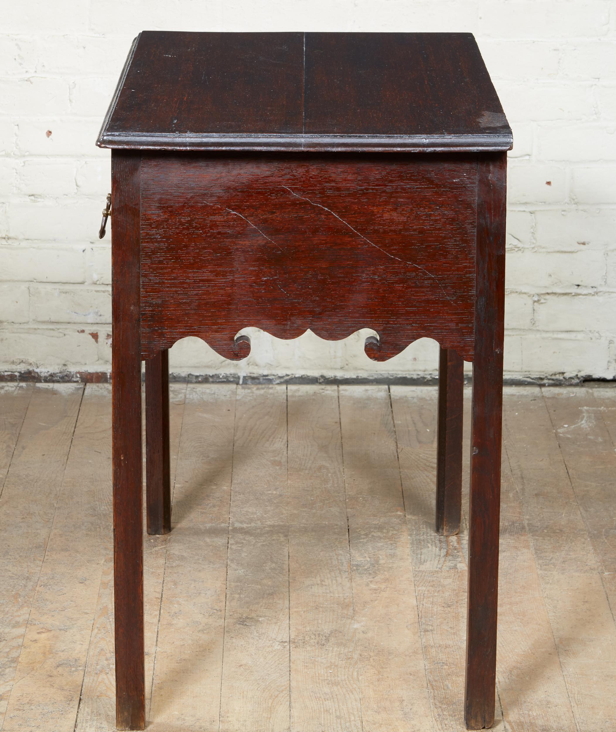 Fine and quirky Welsh oak lowboy, having rectangular top with ogee molded edge over two deep and one shallow drawer, and having boldly pierced apron and spandrels with Celtic knots and gothic tracery, standing on four square Marlborough legs, the