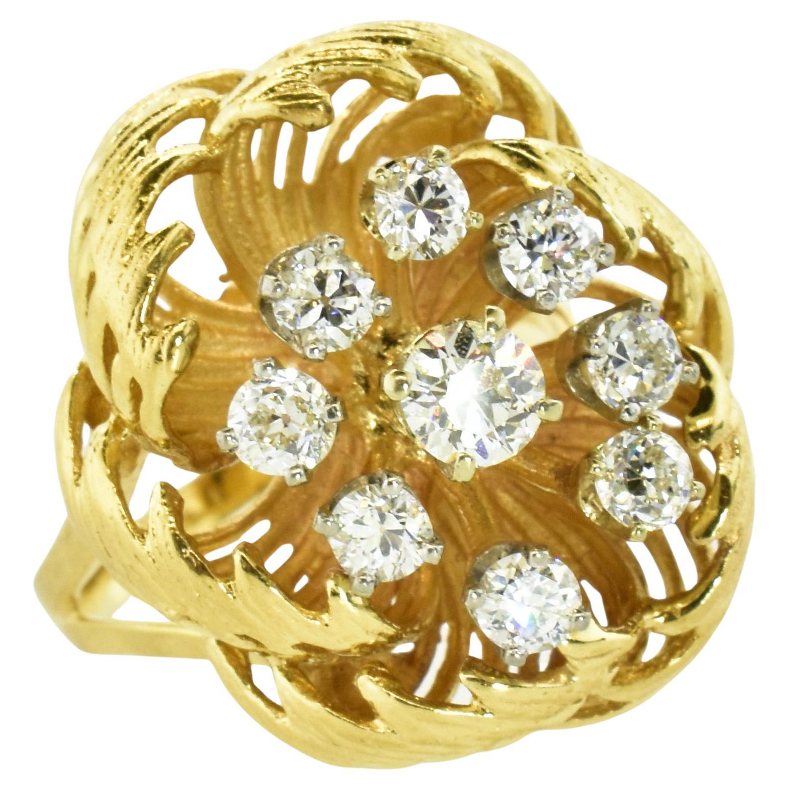 This large yellow gold ring with a flower motif possesses 9 well cut round brilliant cut diamonds prong set in white gold.  These diamonds weigh an estimated 1.35 cts., and are near colorless (H), and very slightly included (VS).  This ring weighs