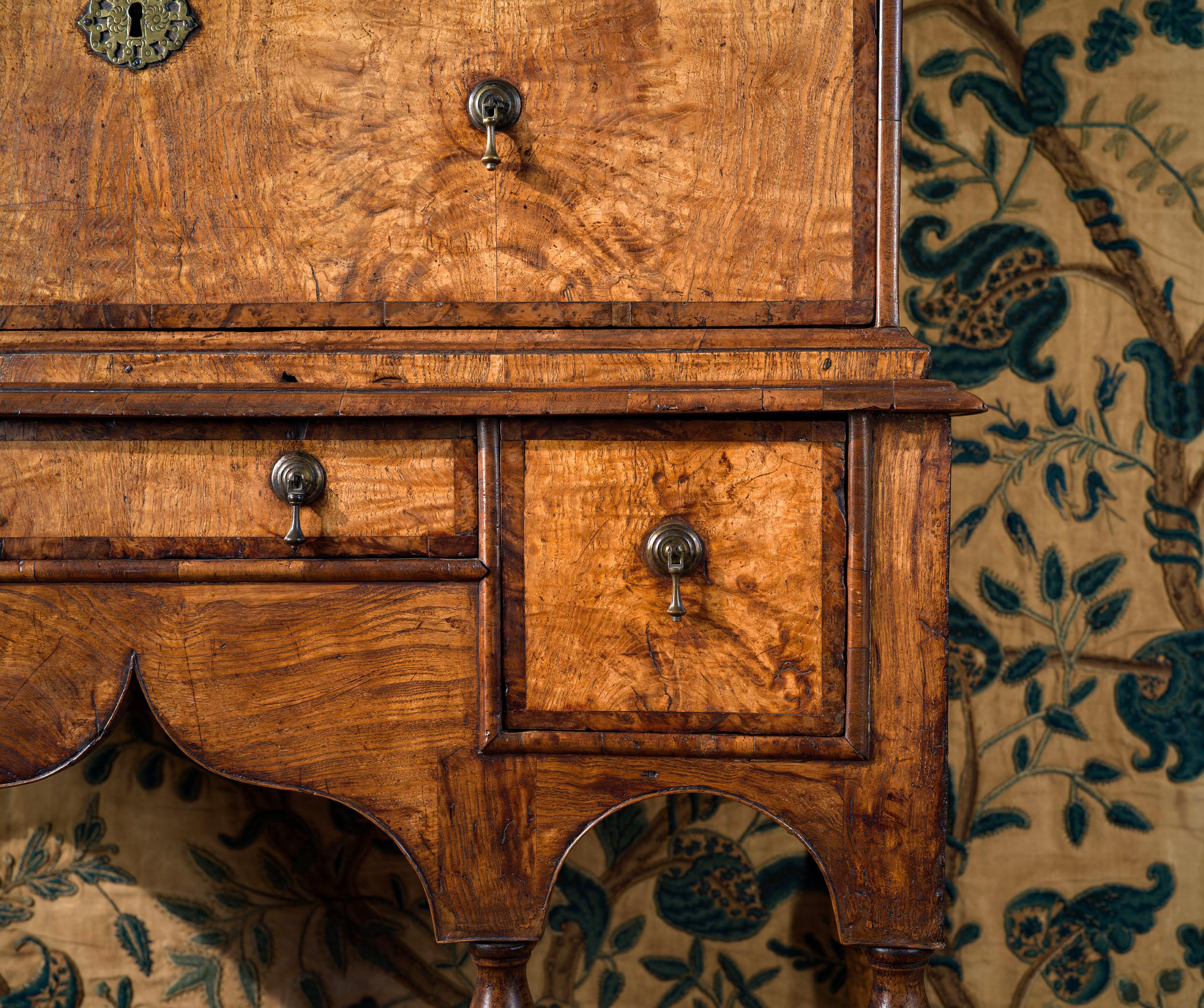A very fine William and Mary chest on stand, in a rare combination of burr ash and burr yew. The chest has a cross grained moulded cornice above two short and three long graduated drawers, the drawers in burr ash, crossbanded in yew. The pear drop