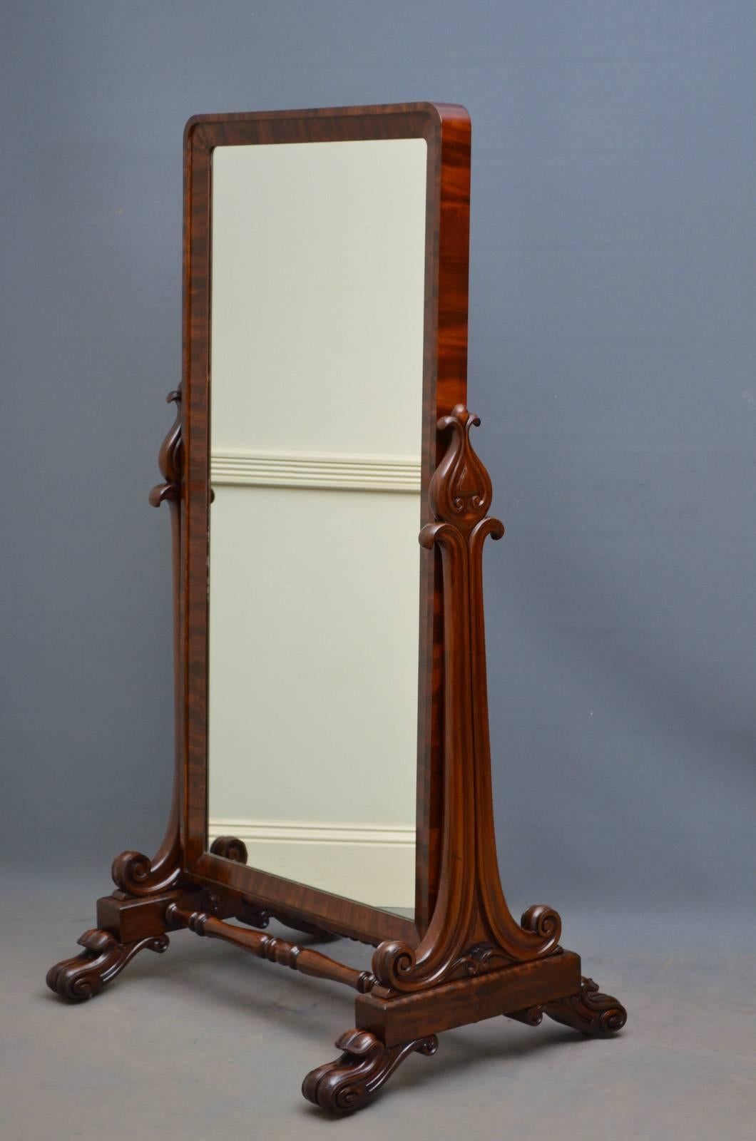 Sn4356 William IV mahogany cheval mirror, having flamed mahogany mirror frame in finely carved supports terminating in scroll feet all united by turned double stretcher all standing on original brass castors. This antique mirror retains its original