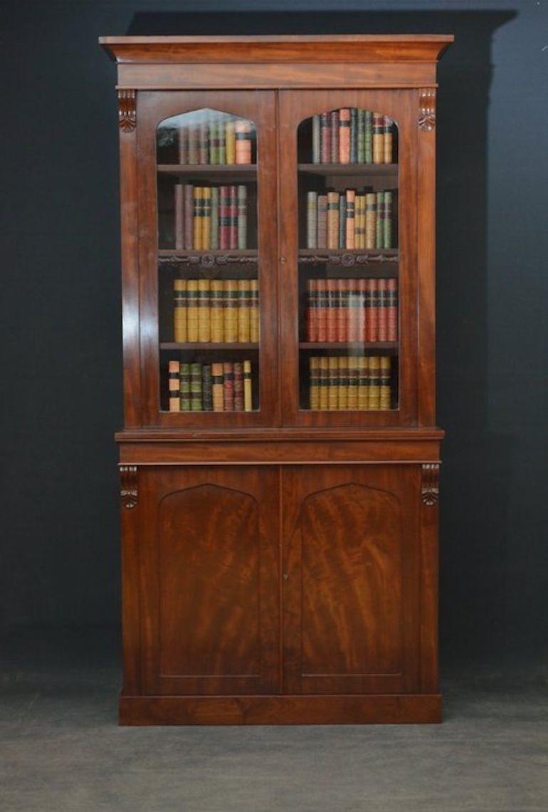Sn3519 Fine quality and very elegant, William IV chiffonier bookcase in mahogany, having moulded cornice above a pair of glazed doors enclosing 3 height adjustable shelves and flanked by drop carvings, projecting base with figured mahogany, panelled