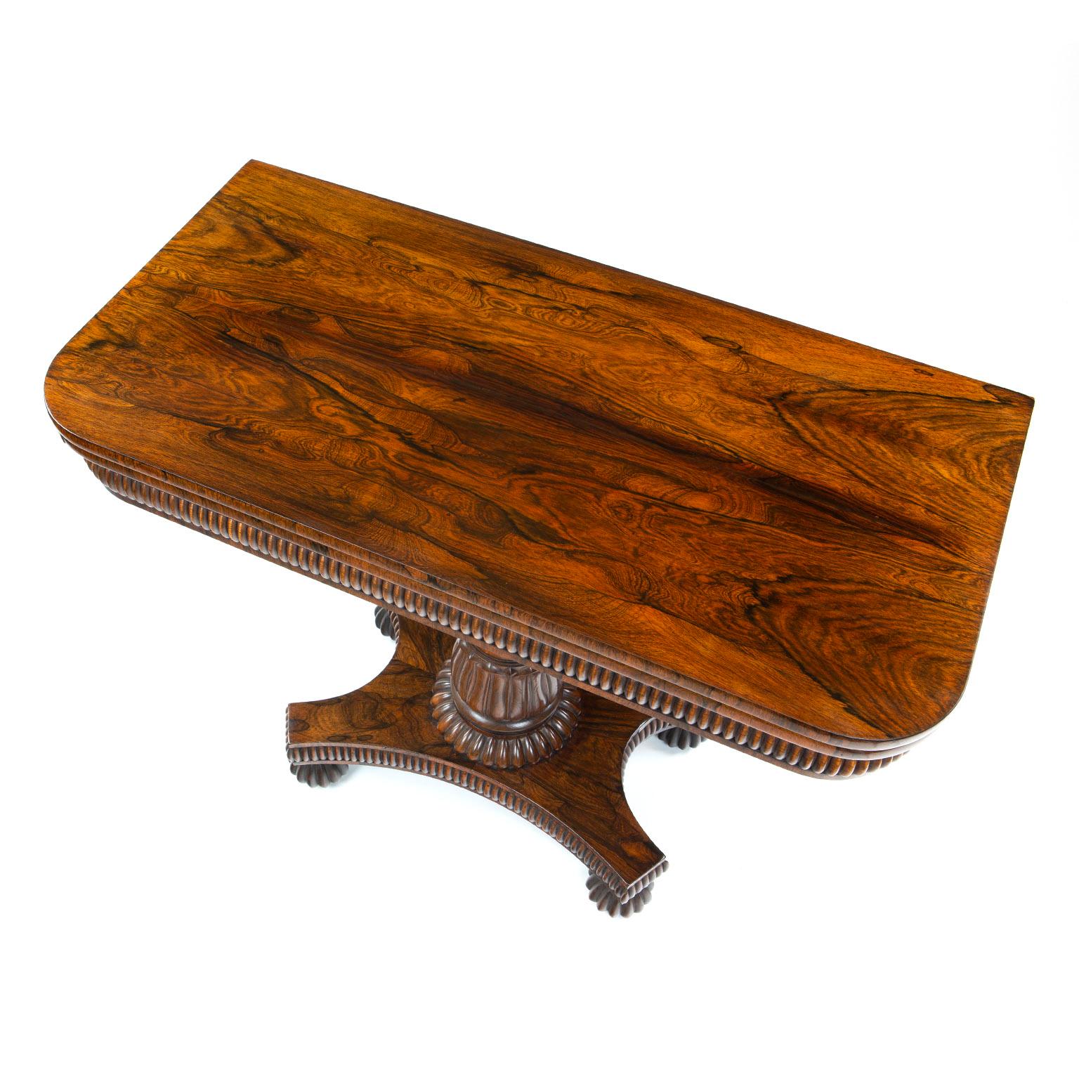 Fine William IV rosewood card table, attributed to Gillows, the fold over rectangular top above a gadrooned frieze raised above a tulip footed column, a gadrooned collar above a platform base with gadrooned edge and further gadrooned