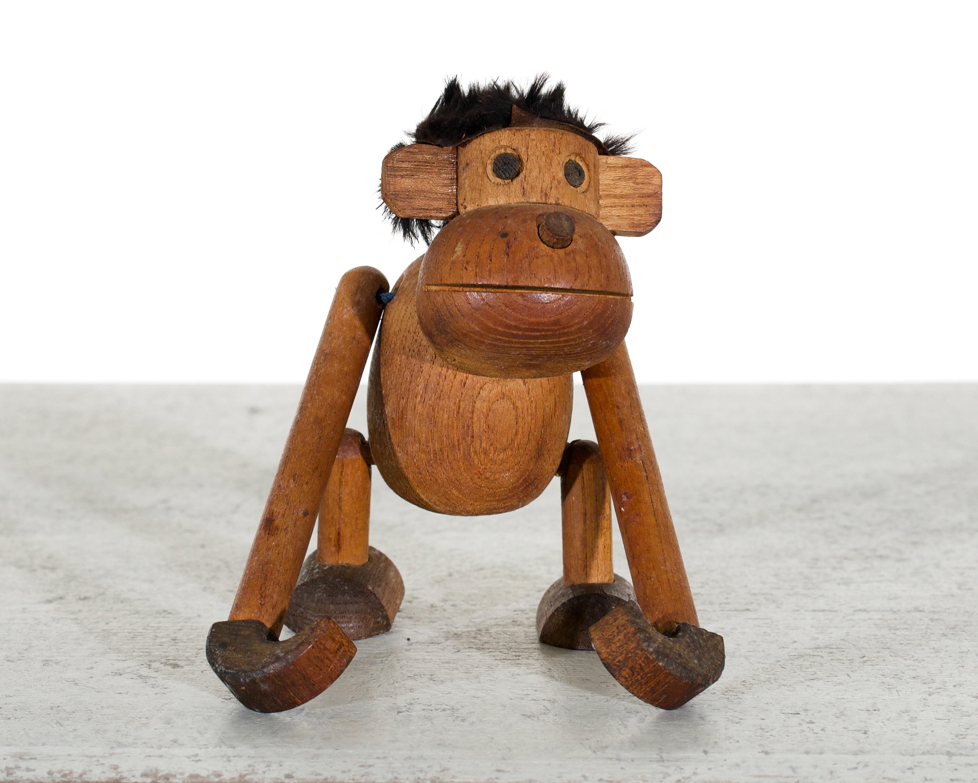 This is a very fine wooden carved monkey. It is likely an early work by renowned Danish designer, Kay Bojesen. It was probably created in the 1950s.