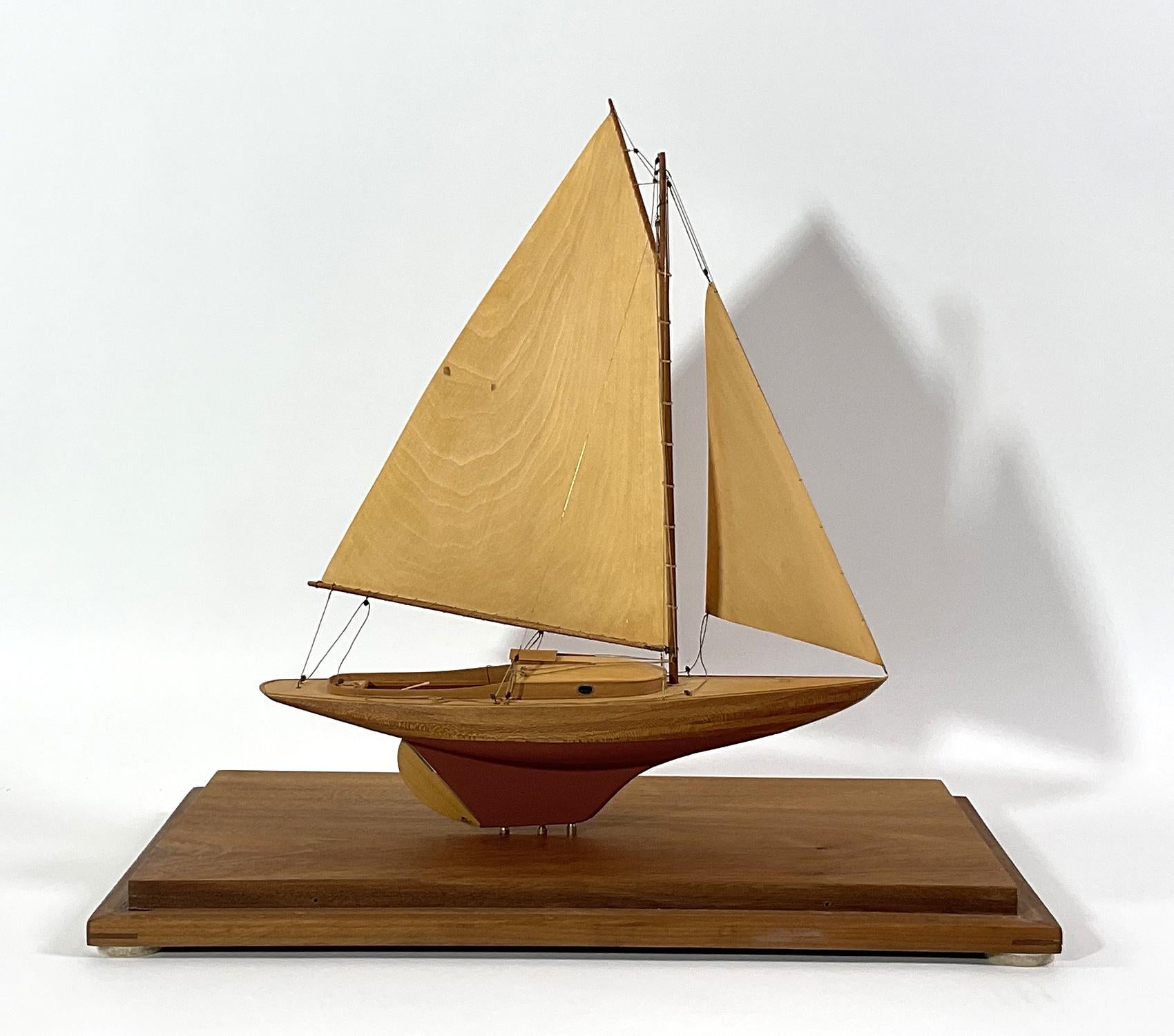 Well crafted model of a Wianno Senior. With laminated mahogany hull. Carved birch sails. Sunken cockpit with bench. Very high quality model. Fitted to a custom case. Attributed to Rob Wadleigh. Circa 1980.