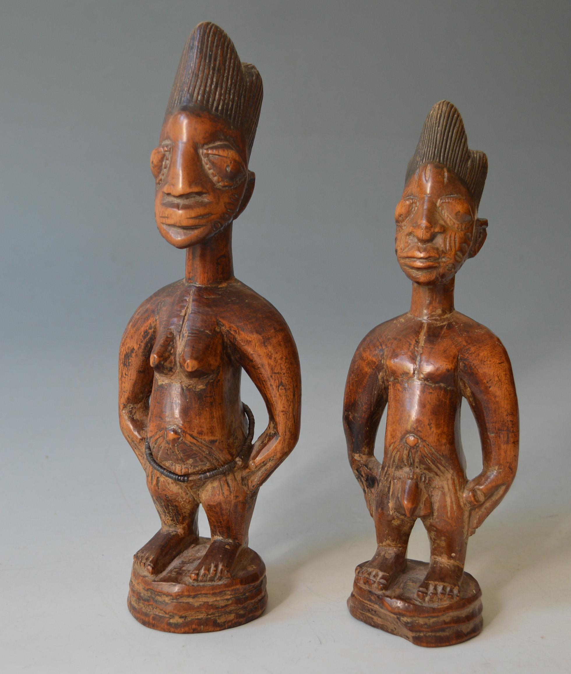 African tribal art.
Fine old male and female pair of Yoruba Ibeji Figures from the Igbuke carving workshop in Oyo. 
Igbuke was a known carver of Ibeji figures and this style is attributed to his workshop 
Measure: height 29 cm. 27 cm
Fine old