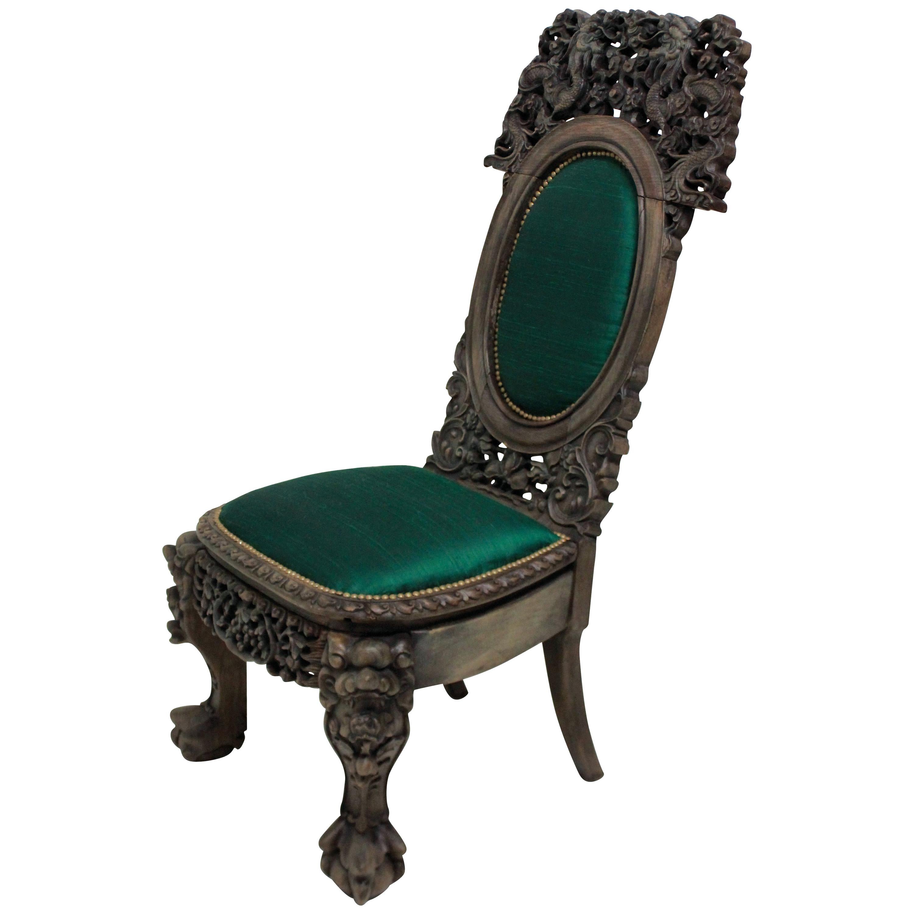 A beautifully carved 19th century Chinese bleached hardwood chair. Depicting beasts and dragons among foliage, upholstered in emerald green silk.

  