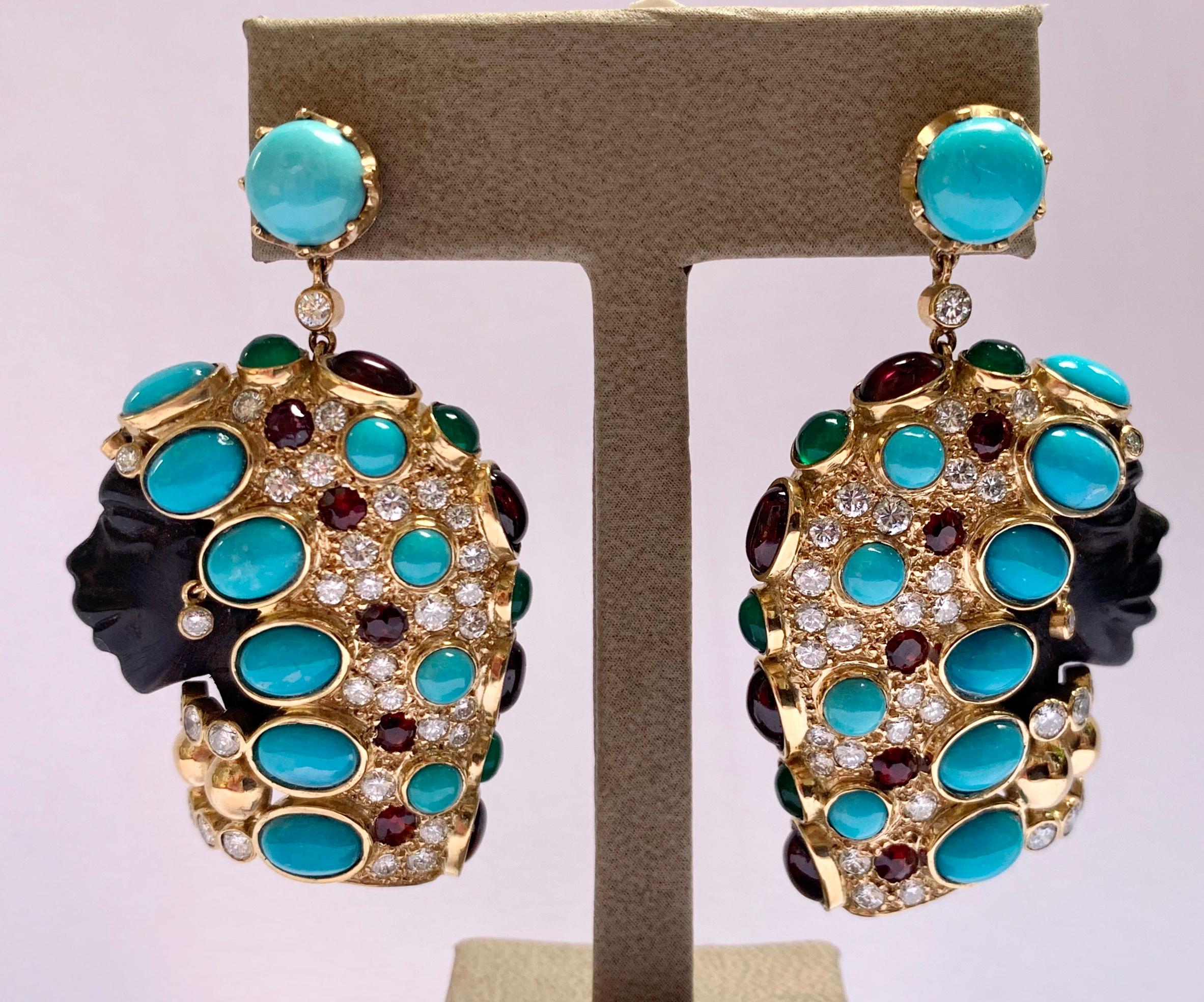 Finely carved, beautiful African female mounted on an 18 K gold base. The face is  ebony and the head is beautifully decorated with Turquoises, Diamonds, Gartnets, Tourmalines and Emeralds. A truly unique and spectacular piece. 
Every woman will be
