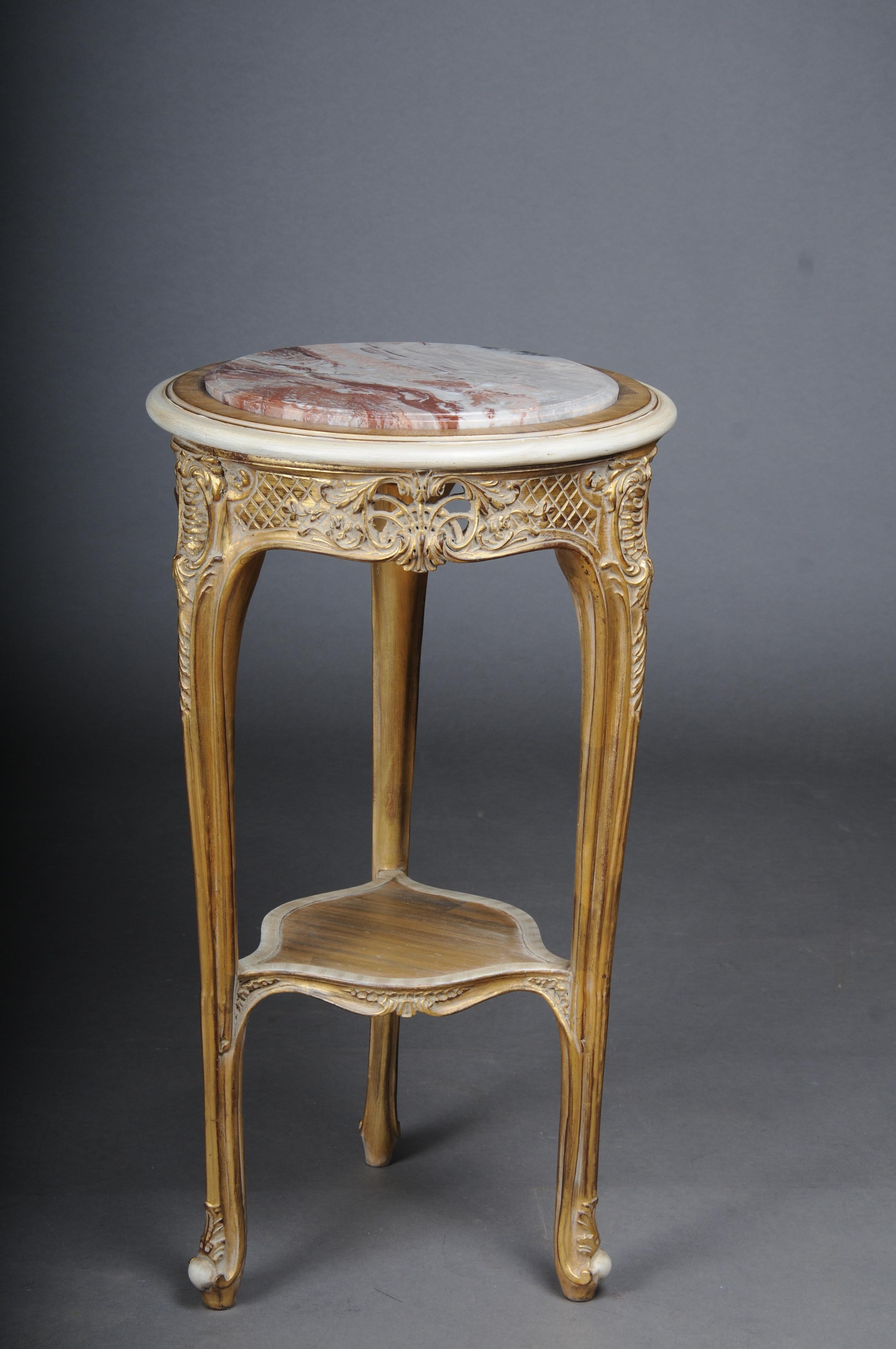 Finely carved gold side table with marble top, Louis XV white/gold

Excellent French Louis XV style table.
High-quality, solid beech wood, carved down to the smallest detail. Extremely decorative and noble. Round inserted and profiled marble slab