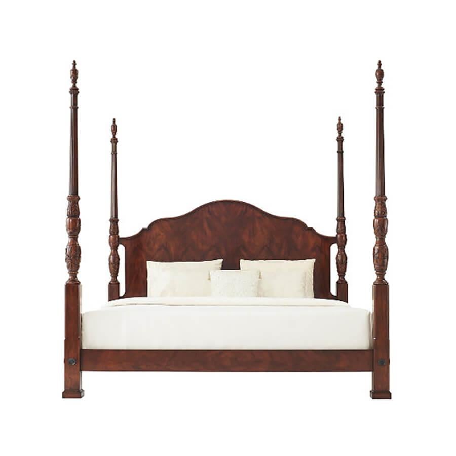A finely carved mahogany and figured mahogany rice bed, the serpentine arched and molded edge headboard flanked by acanthus leaf and rice carved baluster turned posts with urn finials, the figured mahogany rails with brass rosettes to the posts.