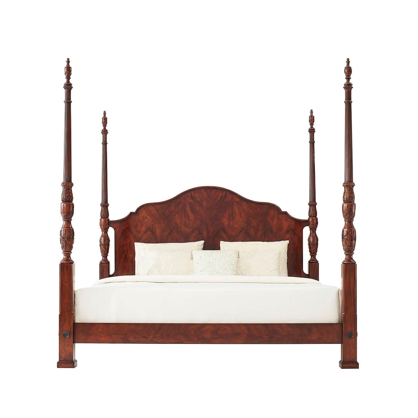 A finely carved mahogany and figured mahogany rice bed, the serpentine arched and molded edge headboard flanked by acanthus leaf and rice carved baluster turned posts with urn finials, the figured mahogany rails with brass rosettes to the posts.