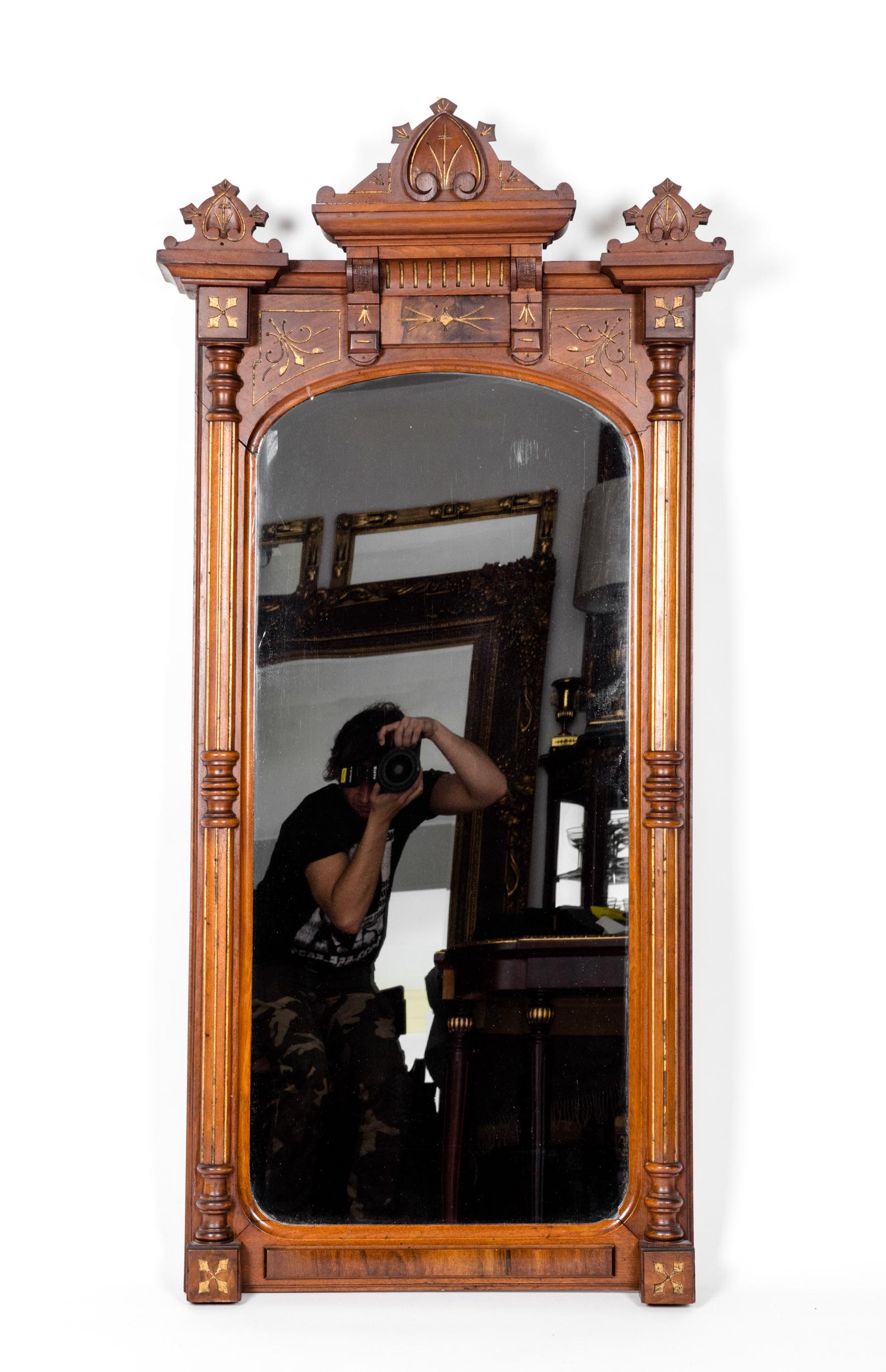 Finely carved mahogany wood framed Victorian style hanging wall mirror with fine carved wood design details. The mirror is in excellent antique condition. Minor wear consistent with age / use. The mirror measure about 53 inches length x 26 inches