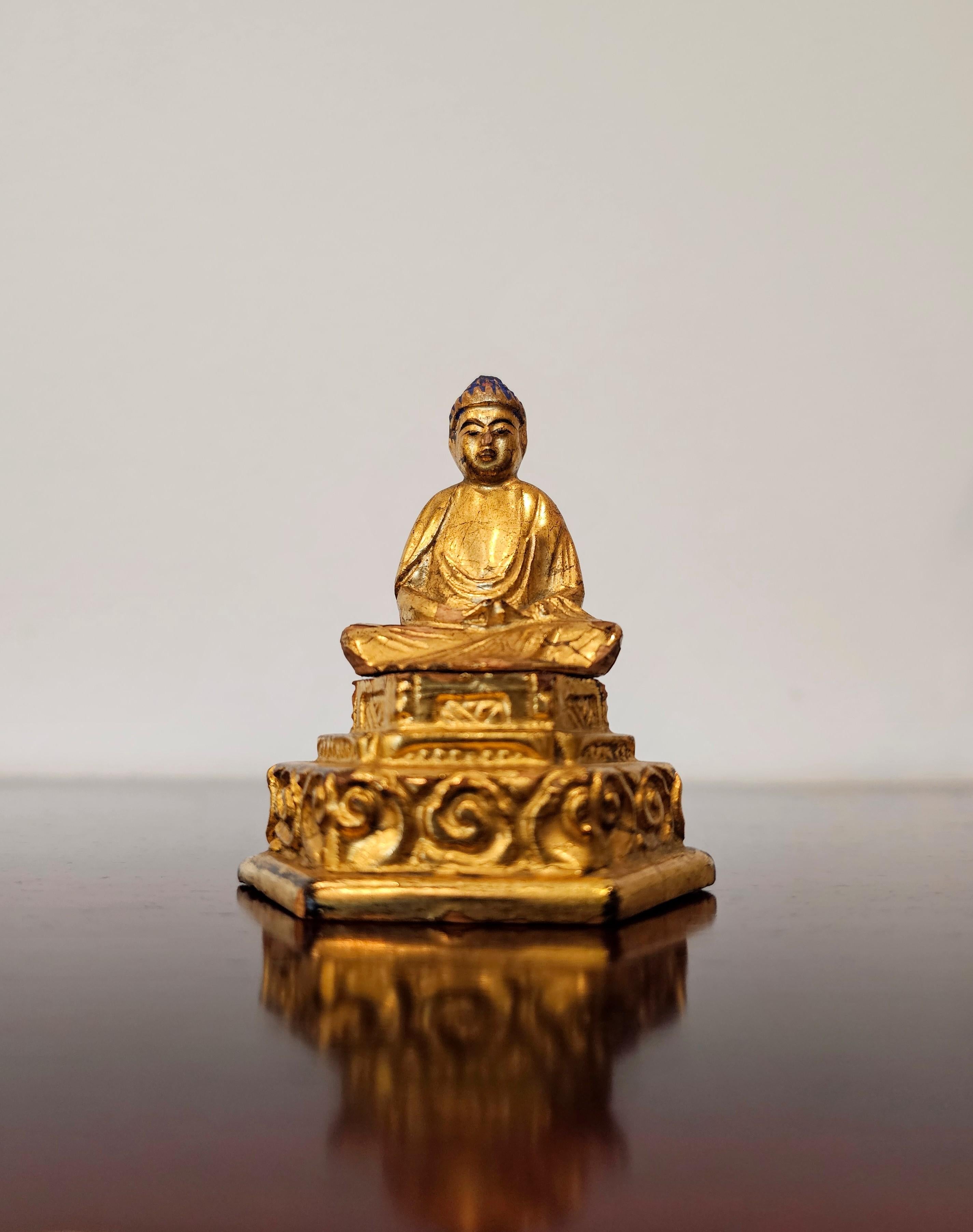 A fine small Edo Period (1603-1868) Japanese hand carved and painted lacquered gilt wood meditating Buddha figure. 

Japan, circa early 1800s or earlier, exquisitely carved diminutive lightweight wooden Buddha sculpture, with blue domed ushnisha