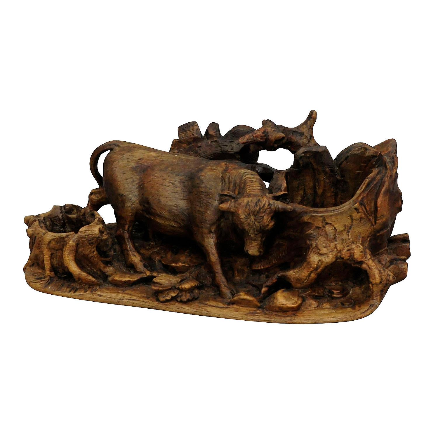 Finely carved statue of a bull ca. 1900

The antique Black Forest carving of a bull which is chafing on a tree stump. It was made most probably in Brienz, Switzerland ca. 1900.

Measures:
Length: 11.02